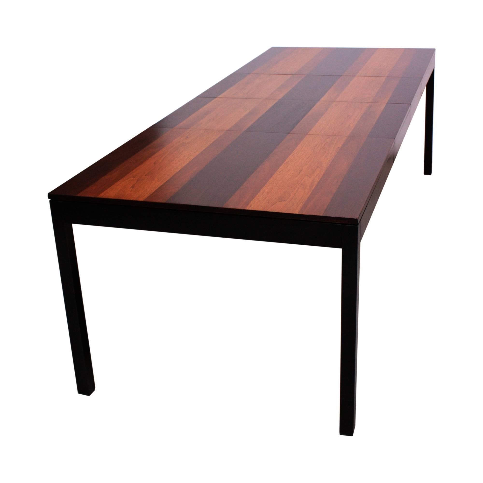 This Milo Baughman dining table was designed for directional and is comprised of walnut, rosewood and English brown oak banding (original black lacquer on legs and apron is intact and is a matte finish- not polished or glossy). The table includes