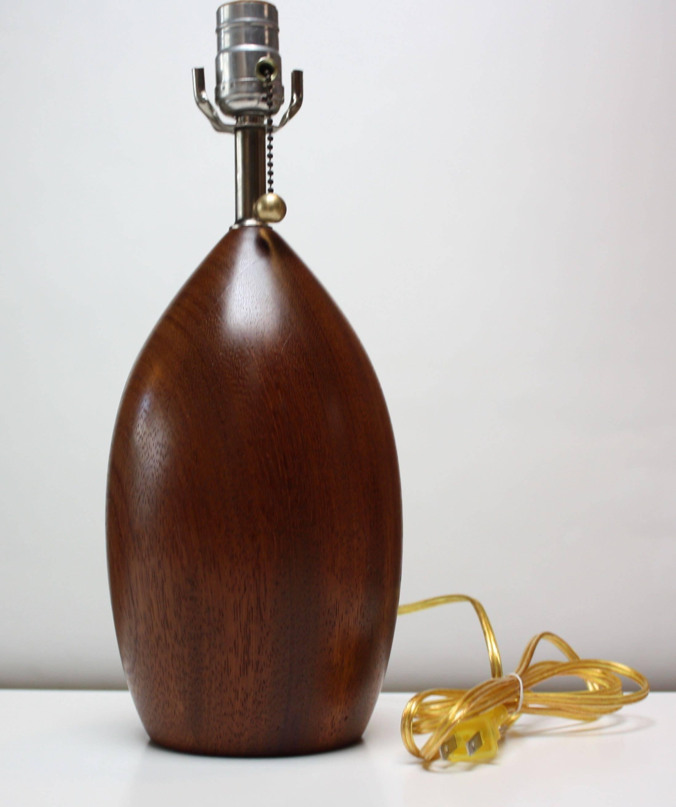This bulbous-form table lamp was turned from a single piece of koa wood boasting rich tone and vivid grain. It has been rewired and the on/off pull string has been added. 
We have the conical version of this lamp listed separately.
   