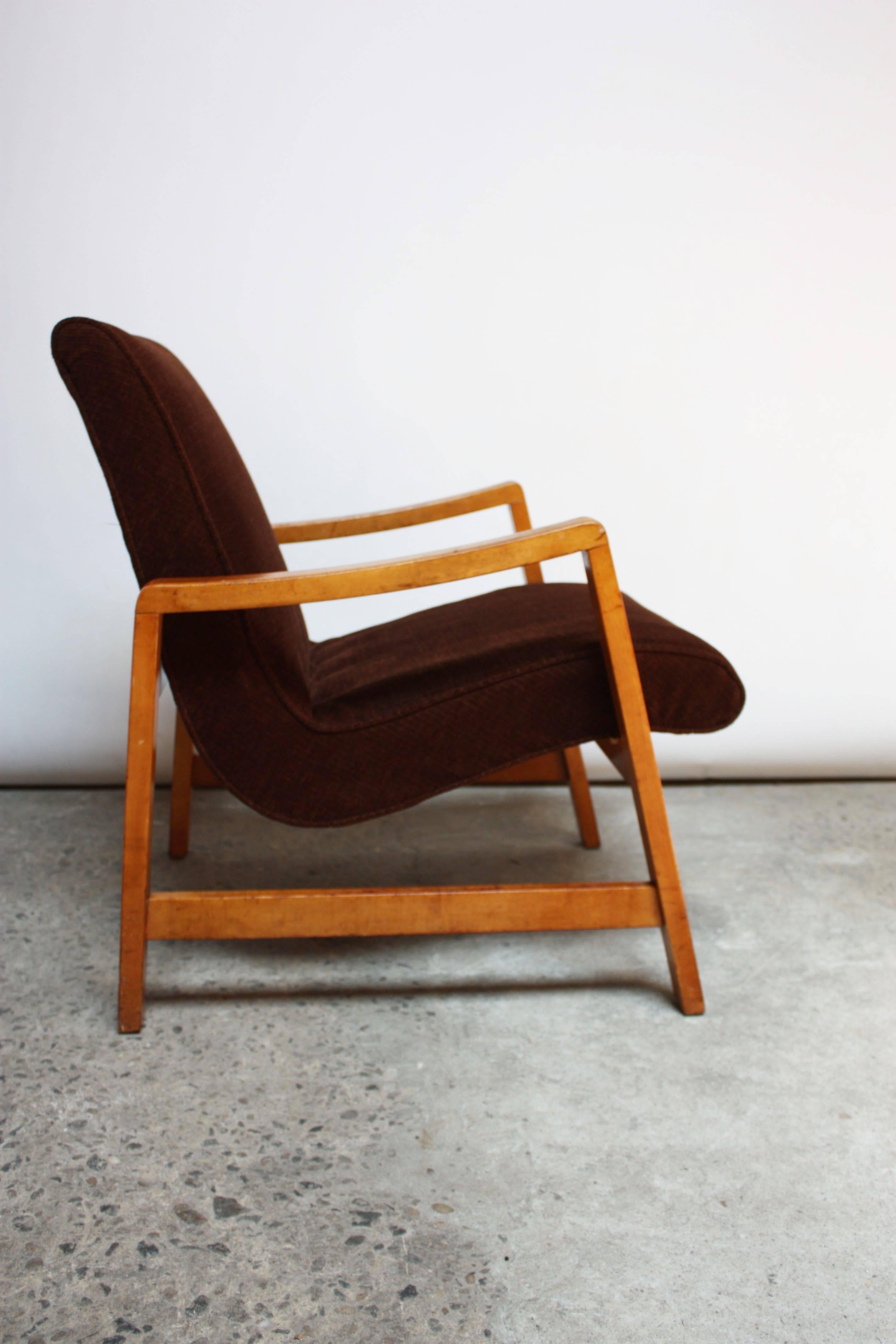 This armchair is an early example of Jens Risom's design for Knoll and is a simple yet innovative design. The chair is two separate pieces: a singular seat / back component is simply inserted directly into a frame supported by a series of inset