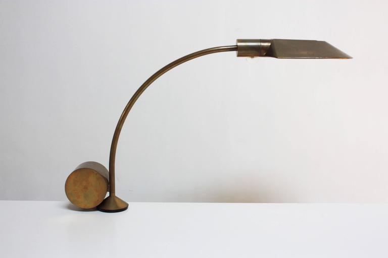 This iconic lamp was designed by Cedric Hartman in the 1960s. Manual movement of the counterweight at the base allows the lamp to seamlessly swivel in a full 360 degree angle. The shade also has full adjustability and Hartman's signature Lucite on /