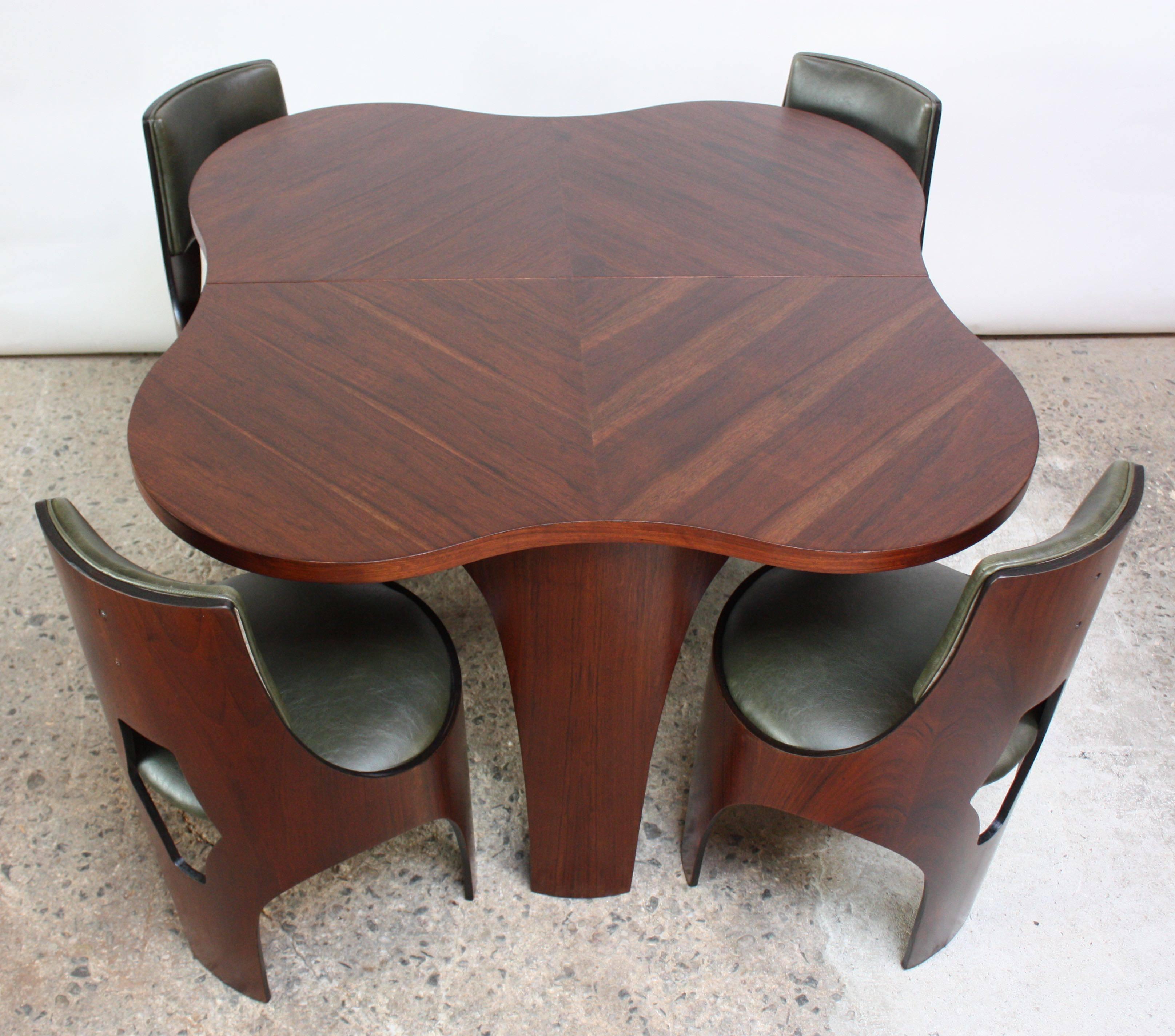 Rare Henry Glass for Richbilt MFG dining set from the 1966 'Cylindra' line, including the table (with two additional leaves) and four chairs in plywood and walnut. Unique, sculptural form and extraordinary walnut grain. 
Original vinyl has been