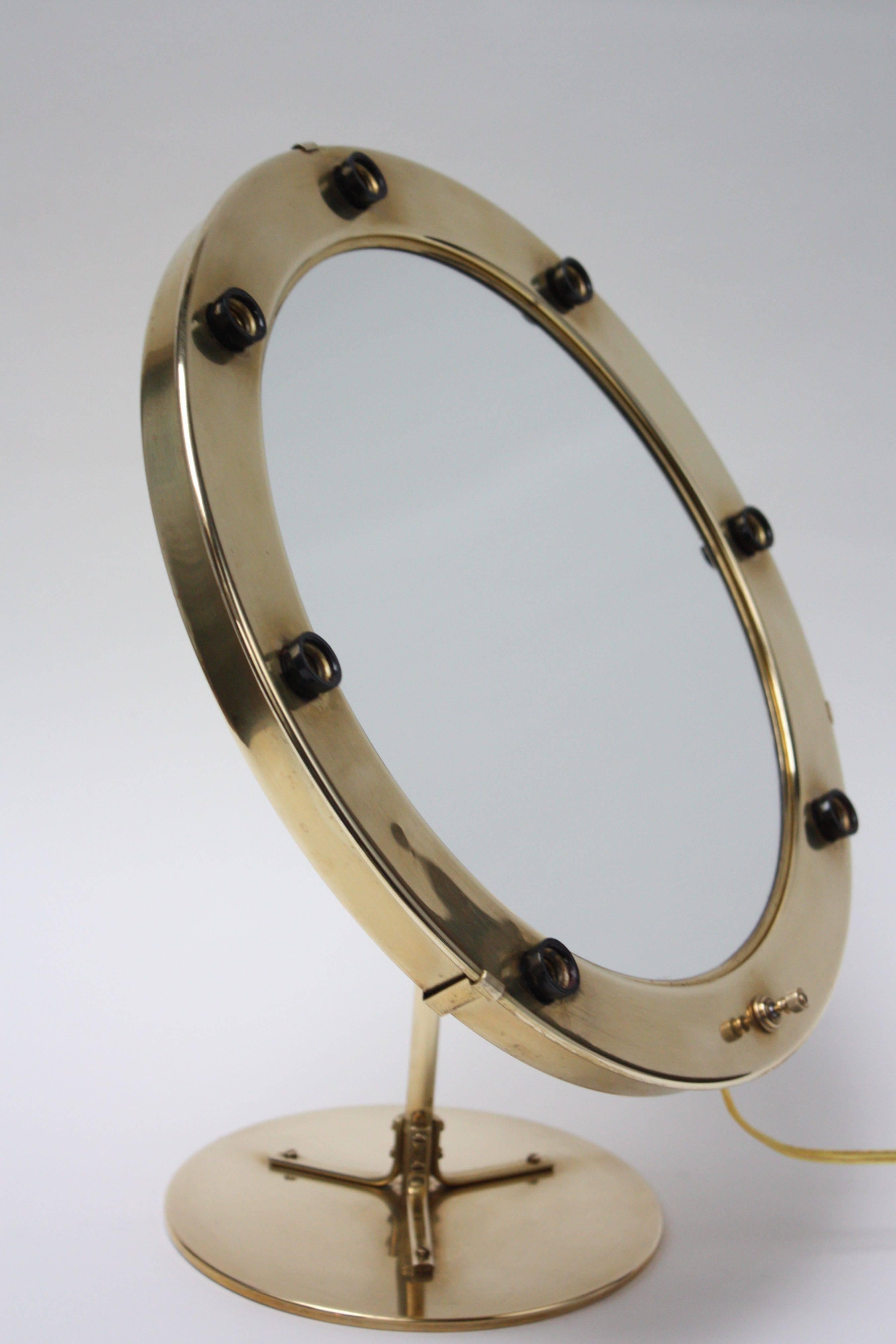 1960s seven-fixture illuminated mirror in solid brass. Newly rewired. Signed 'West Germany' to the underside. 
Mirror itself is in excellent shape free of scratches / scuffs. Brass is in beautiful polished condition.
