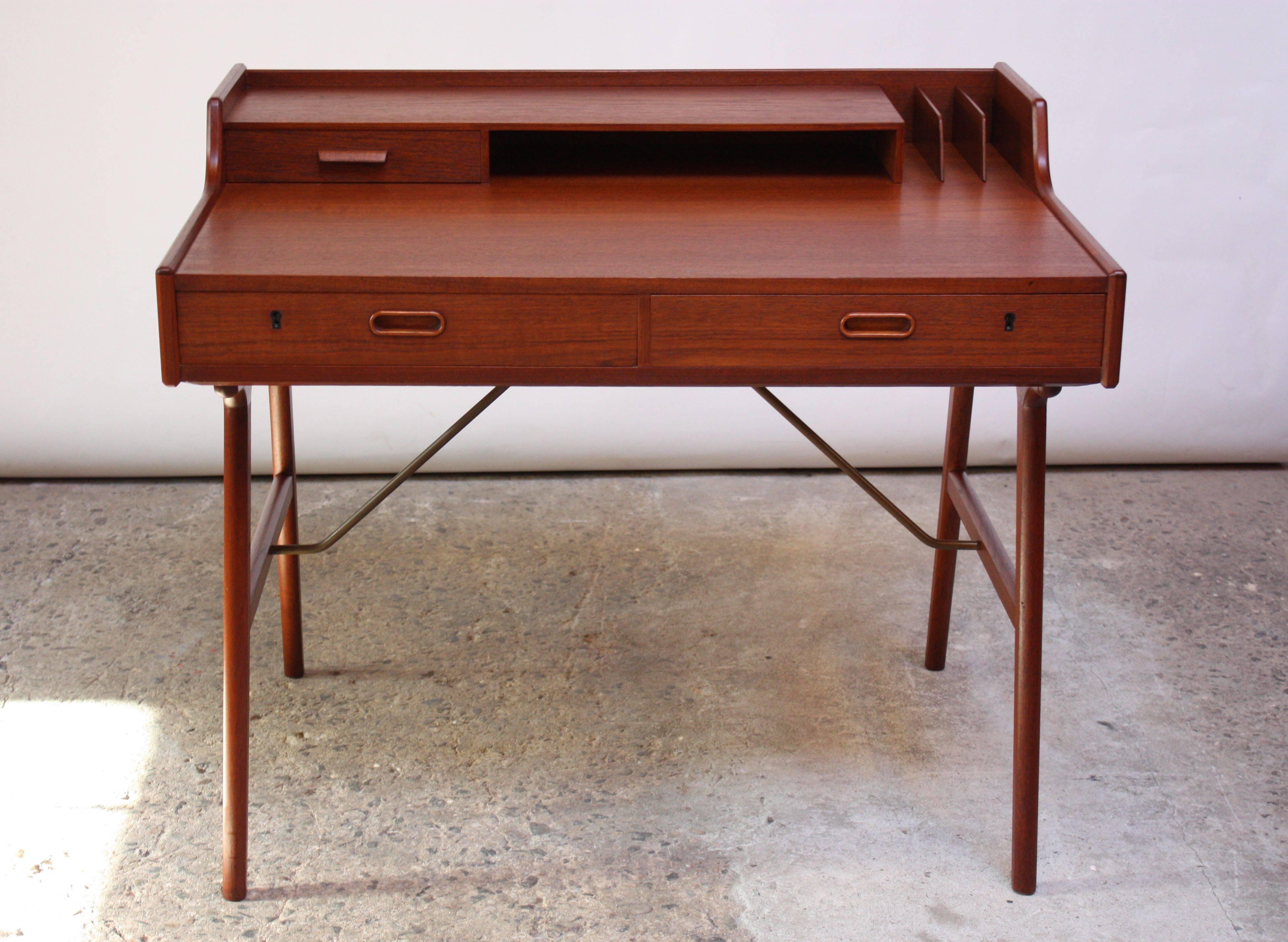 This sculptural desk (model #56) was designed by Arne Wahl Iversen for Vinde Mobelfabrik in 1961. Referred to as the 'Ladies Desk,' given its diminutive size and dual use as a vanity. Features two drawers, each with its own lock, and a second tier