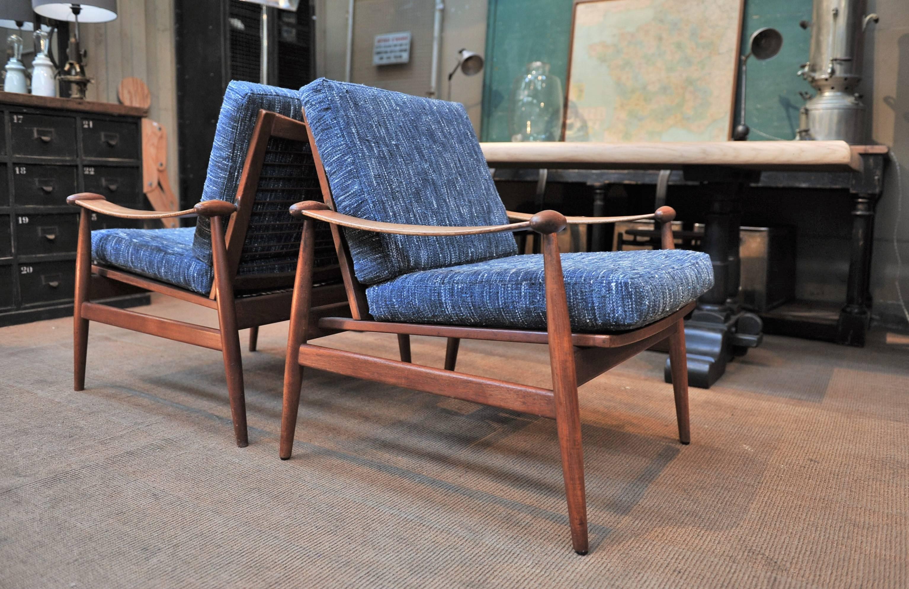 A pair of Finn Juhl's  Model 153 ‘Spadestolen’ or 'Spade' lounge chairs in teak, manufactured by Danish producers France and son  Daverkosen, circa 1955. Newly Reupholstered .
      
    
