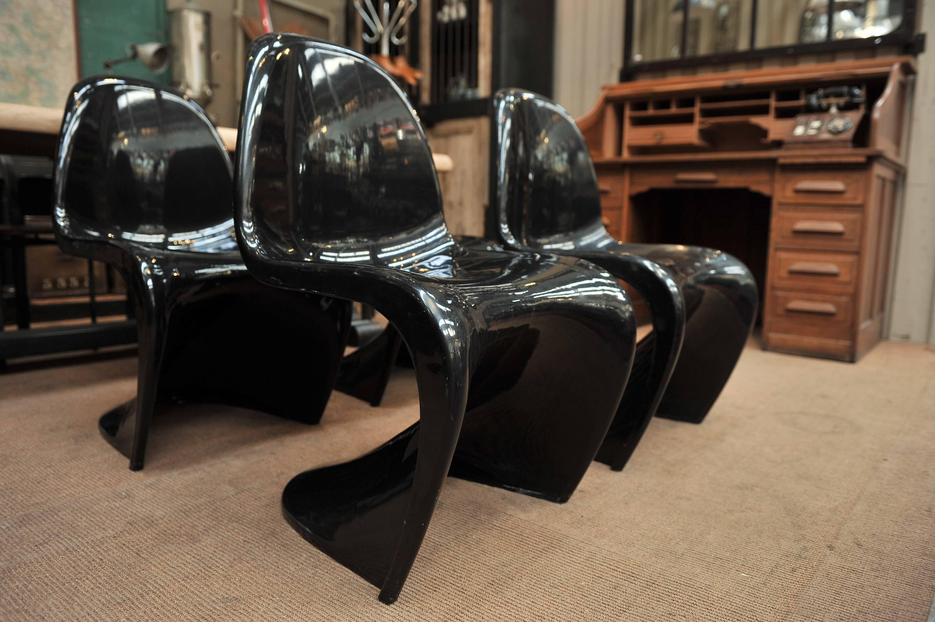 This set consists of four stackable design chairs that were designed by Verner Panton. Polyurethane hard foam (Baydur) painted black. They were produced in the 1980s.
