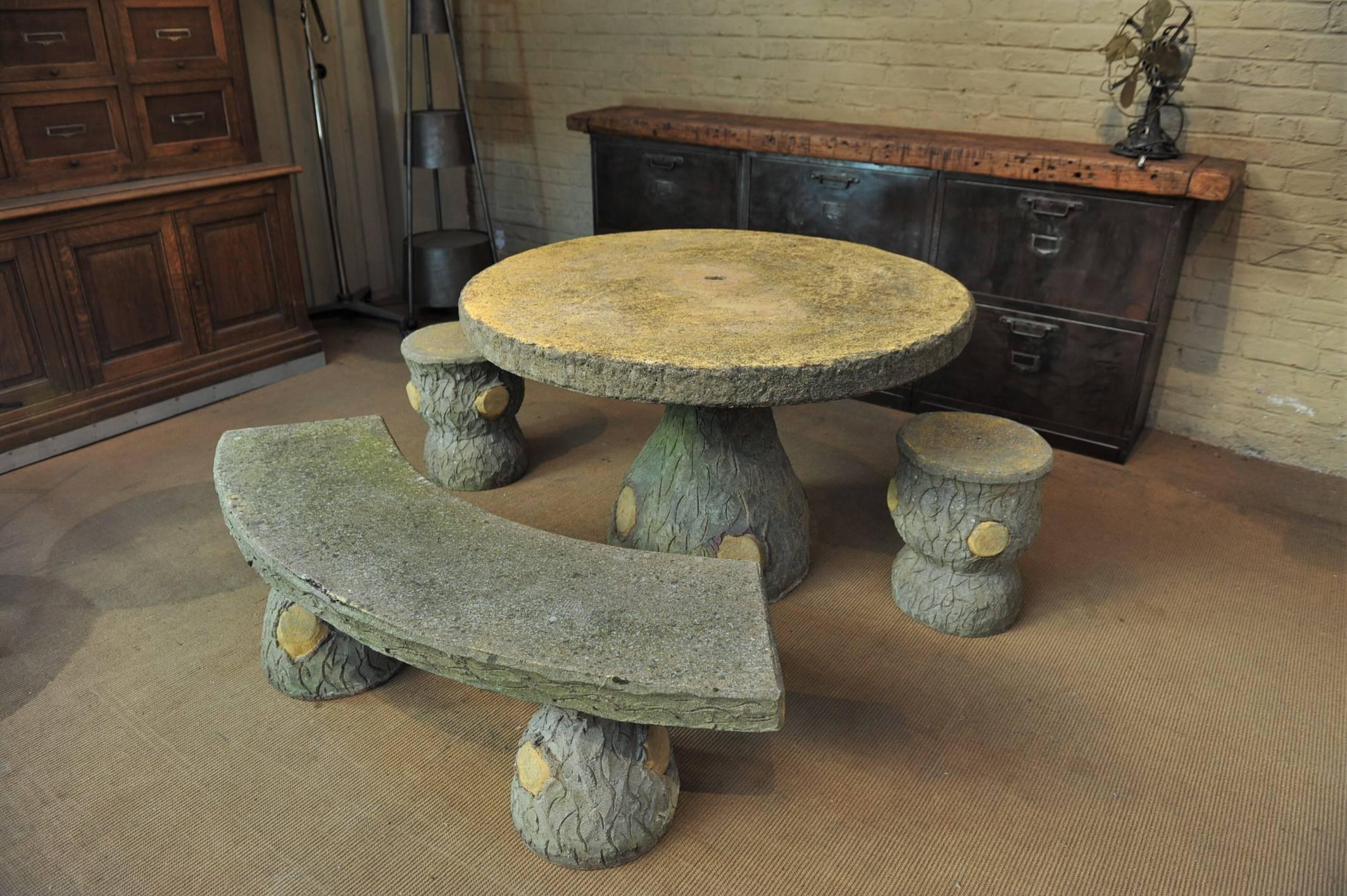 Cement French garden set: One round table one bench with two removable feet and two stools in faux bois, circa 1930s very nice patina.
 Height stools 43 cm diameter: 35 cm bench 144 x 50 cm height 44 cm table diameter: 144 cm. Height 74 cm.