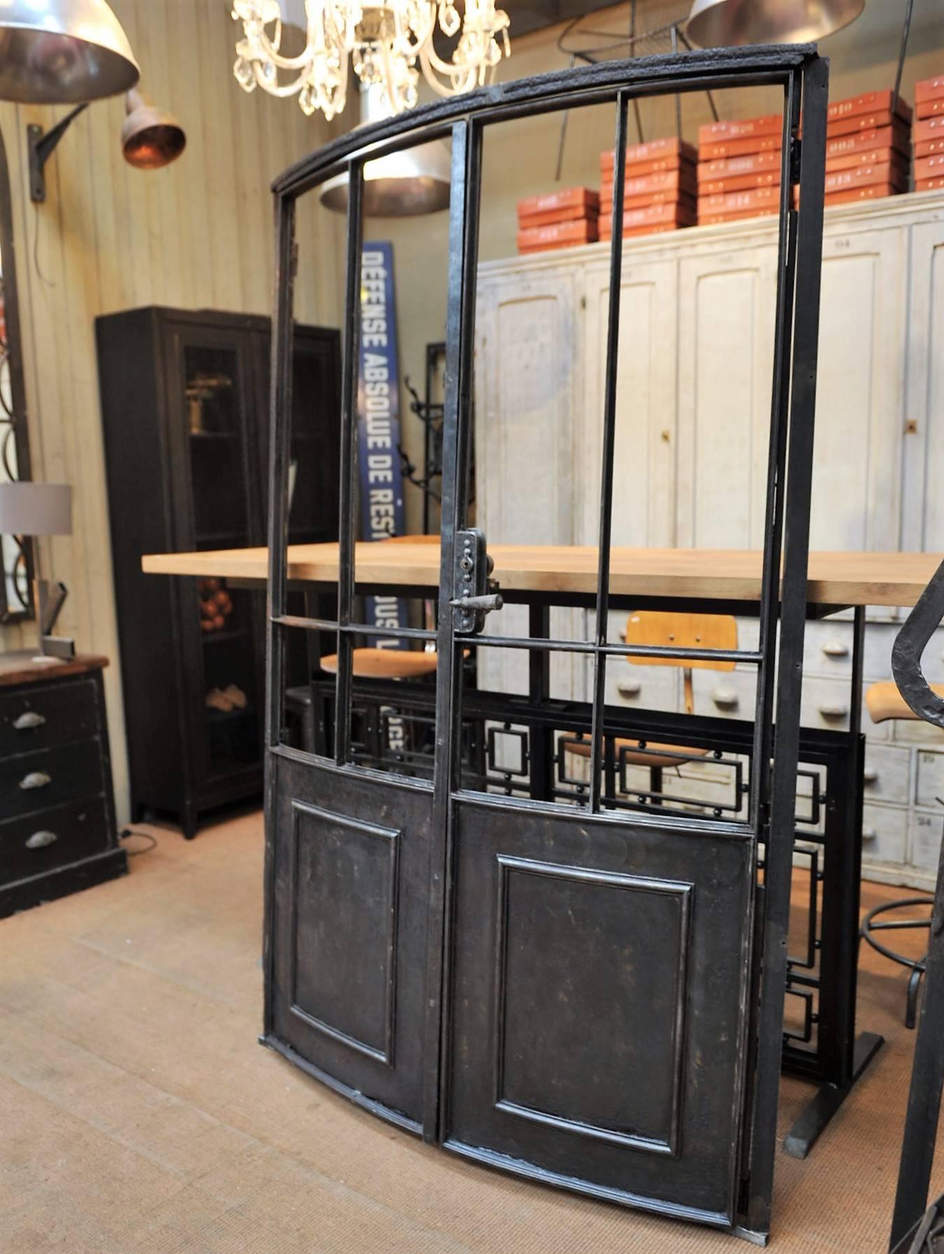 French curved iron double doors, circa 1880 polished and varnished finish.
 Possibility to add glass from the back .