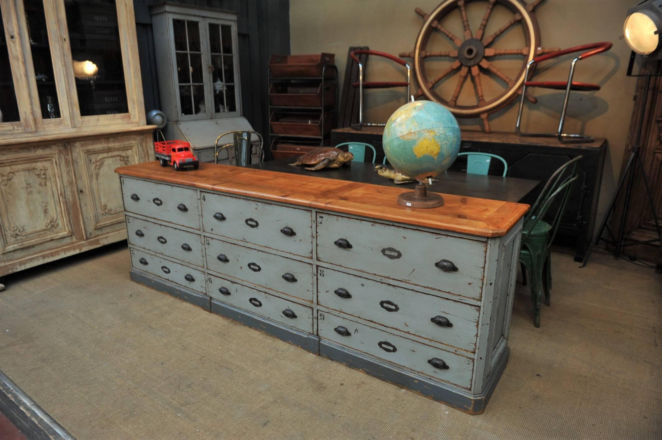 French commerce nine large drawer pine cabinet, circa 1920 new grey patina origional iron handles and tag holder.