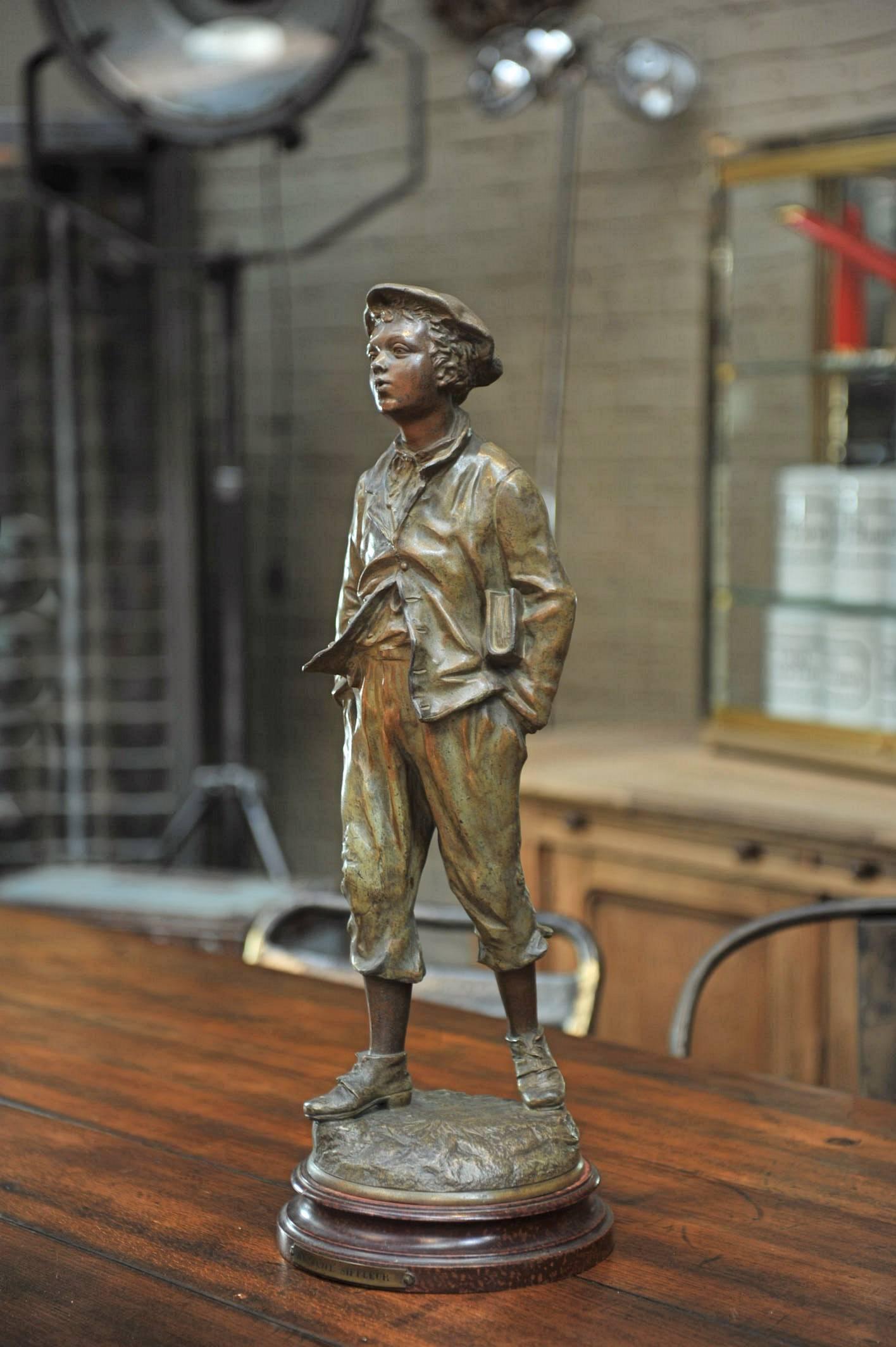 19th century regule statue named Le Petit Sifleur (the little whistling boy) signed Charles Anfrie (1833-1905) France .Orginal faux mable wood base.