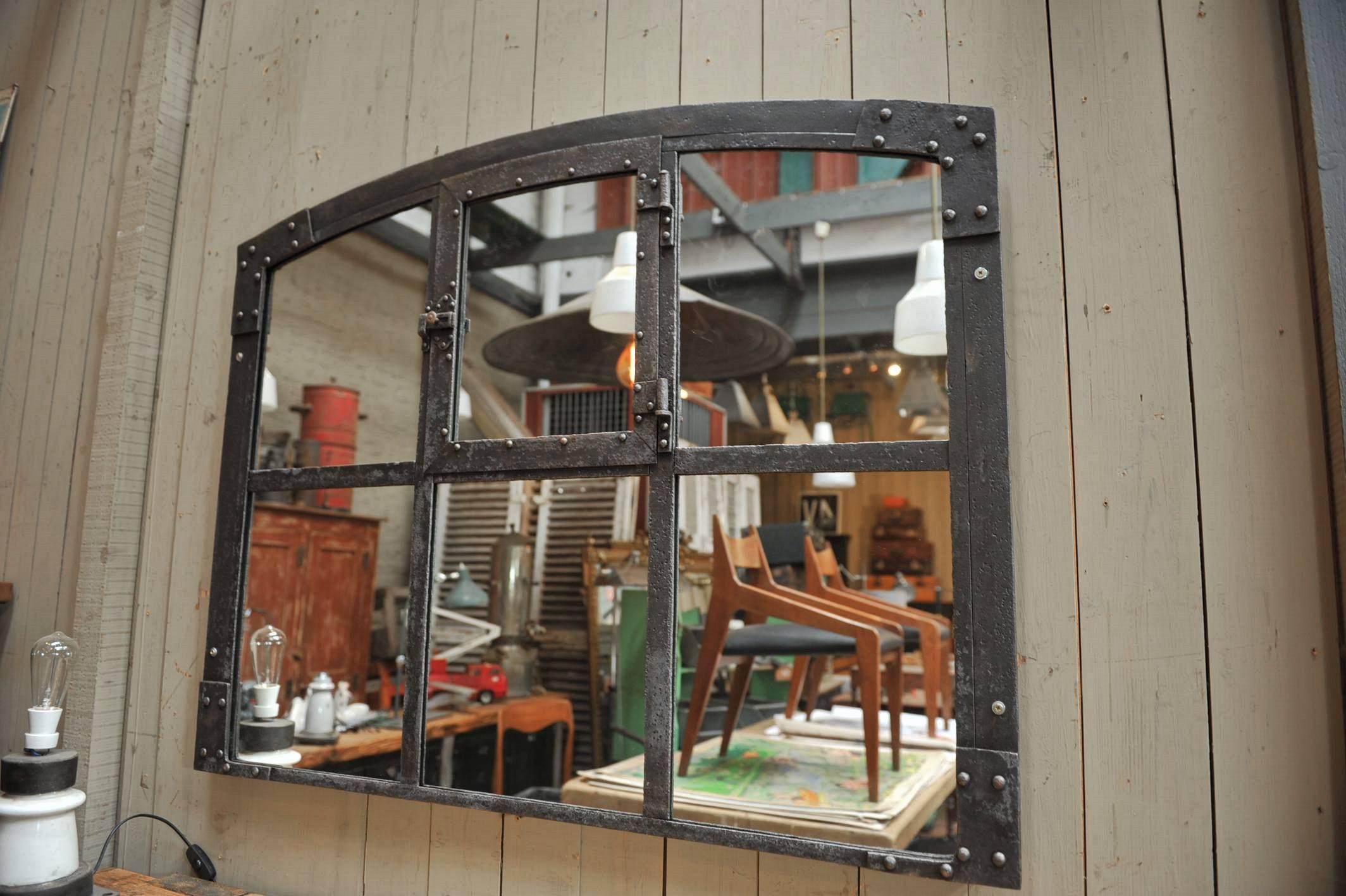 Riveted iron window from French Factory, circa 1900 with new mirrors.
 