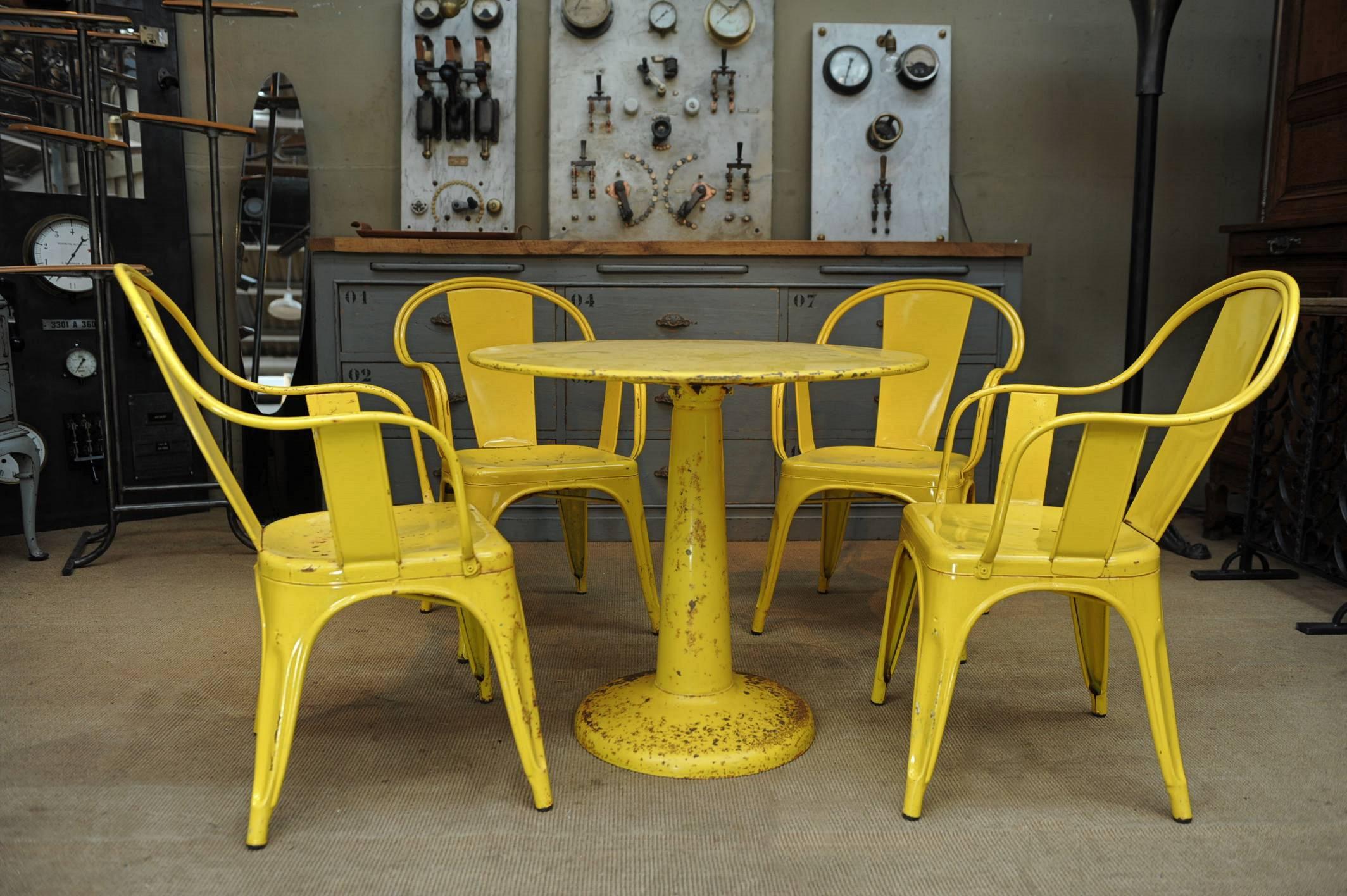 Set of four French bar terrace or garden stackable armchairs and one round iron table all by Tolix , circa 1950 vintage yellow color
All iron in excellent condition ,rusty spots as one the pictures on the patina . Table diameter 80 cm (31.50)