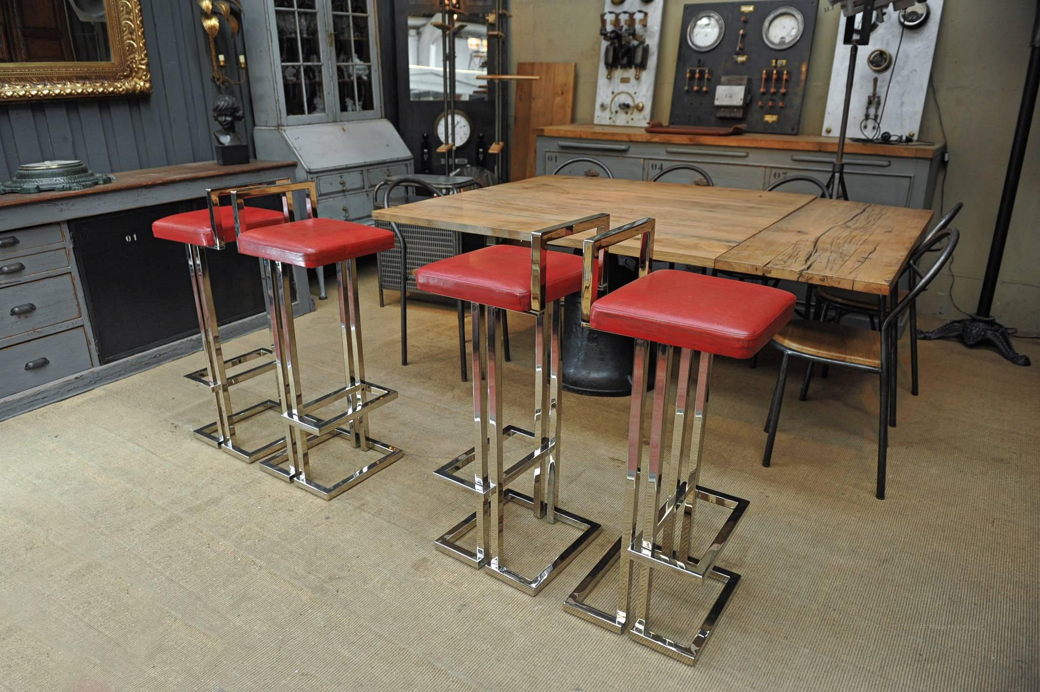 Set of four French Maison Jansen Design bar stools on a chrome-plated frame, with Original Red leather seat pads. Some wear to the chrome plating, circa 1980.

