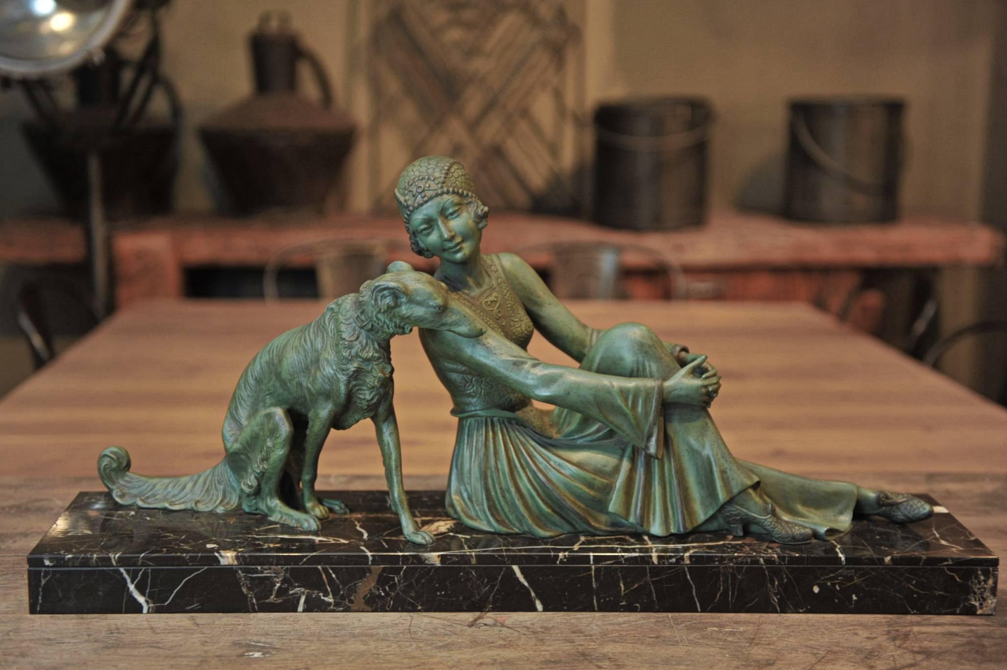 Art Deco French Régule sculpture large statue of woman with dog marble base, circa 1930.
