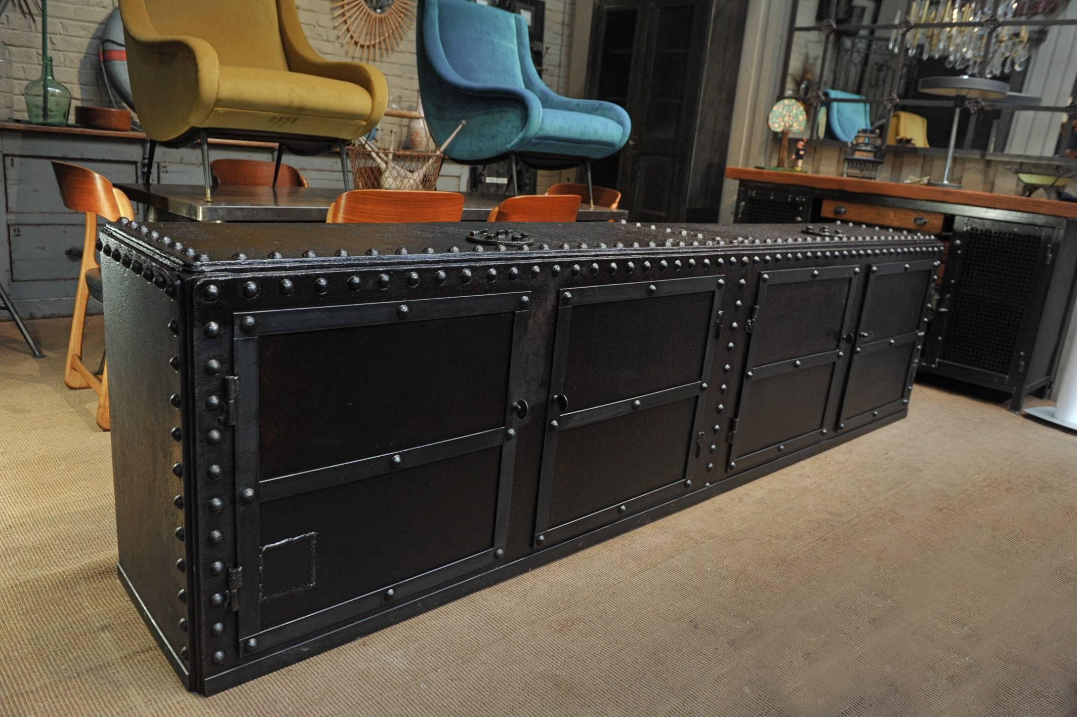 1900 riveted iron French factory trunk opened in four doors with solid oak shelves long credenza cabinet.
   