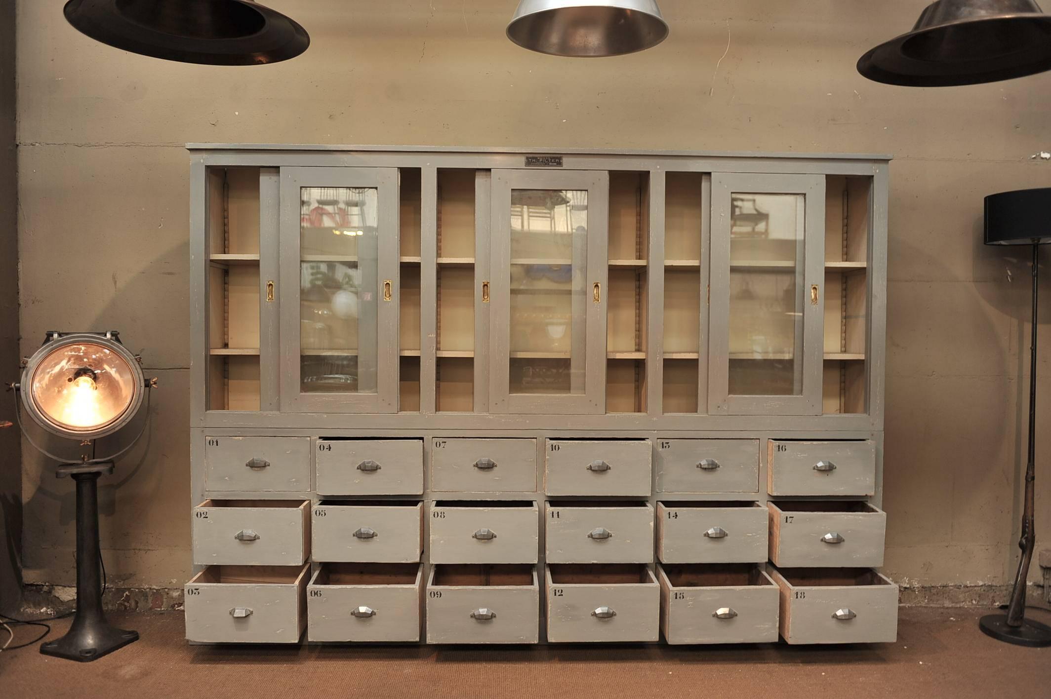 French Vitrine Bibliotheque:6  Slidind Doors and 18 Drawer  pine Shop Cabinet Circa 1900
 New outside Grey Patina Original inside white Patina.
 Drawer Handles where changer in the 50s.