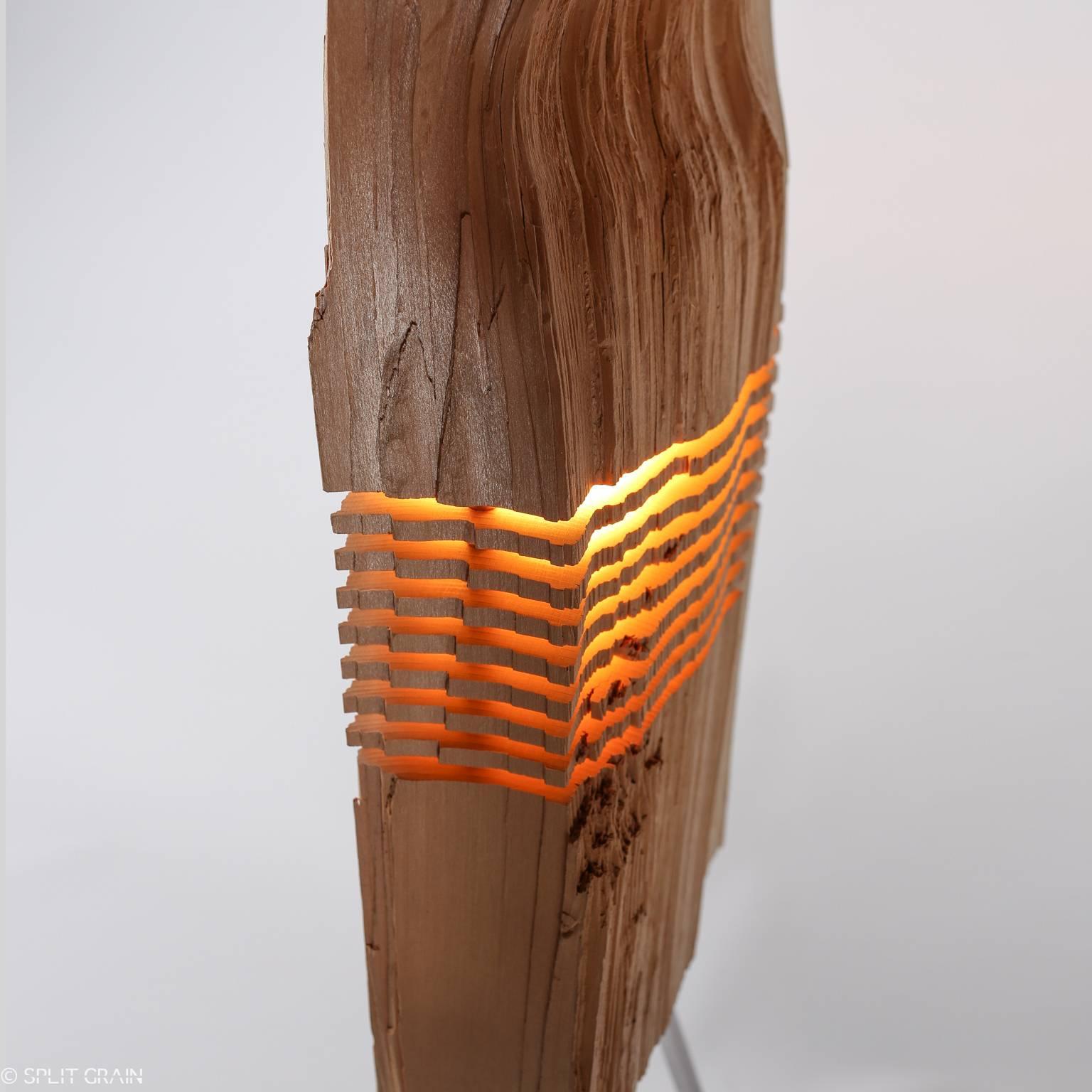 One of a kind split grain light sculpture is made by 20th century artist Paul Foeckler from a reclaimed California Incense Cedar with a hollowed core that is illuminated with a built-in dimmable LED bulb and suspended on an aluminum armature.
    