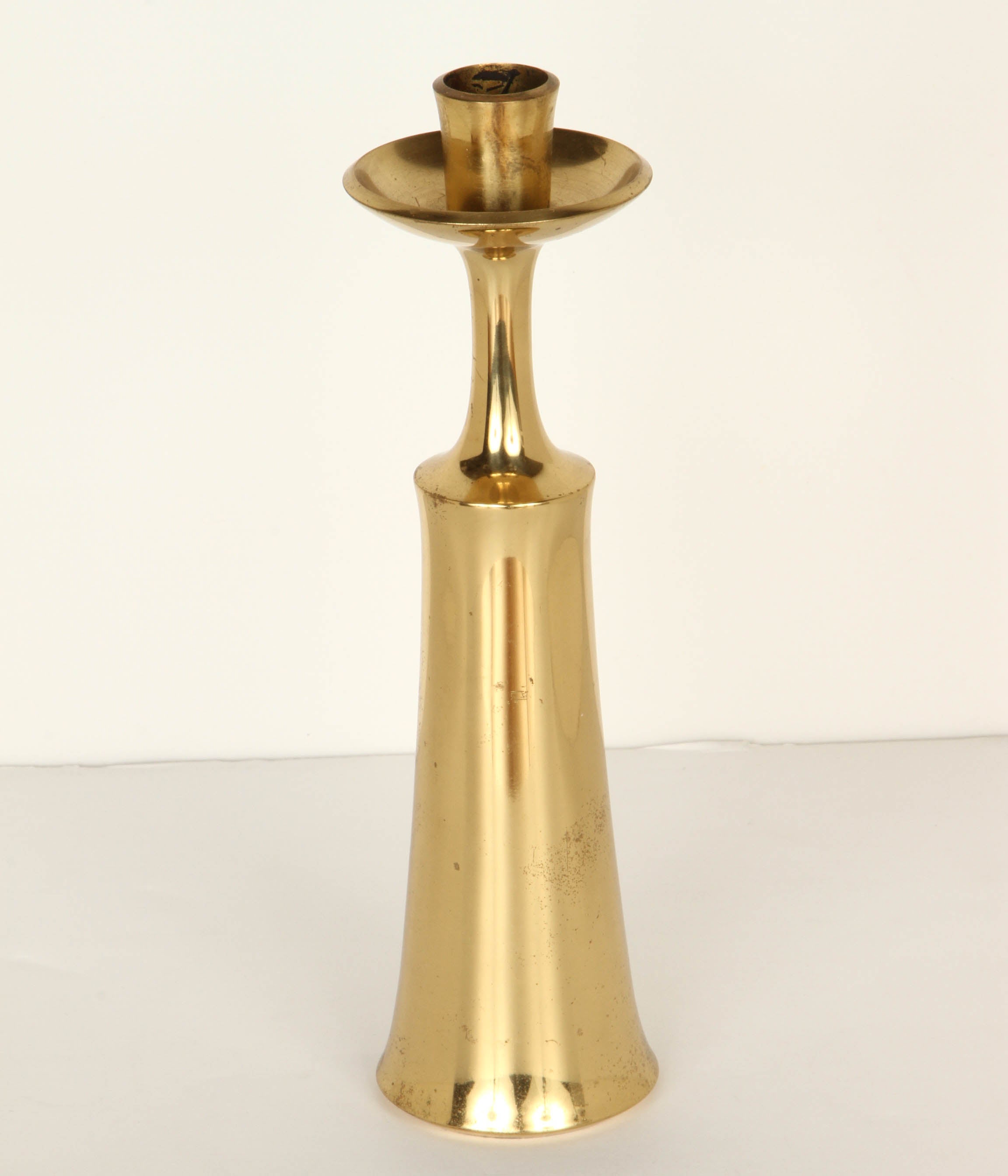 A pair of 1950s Jens Quistgaard brass candlesticks for Dansk. One of his most noteworthy and iconic designs. Quintessentially Danish modern in its execution and inherent aesthetics.