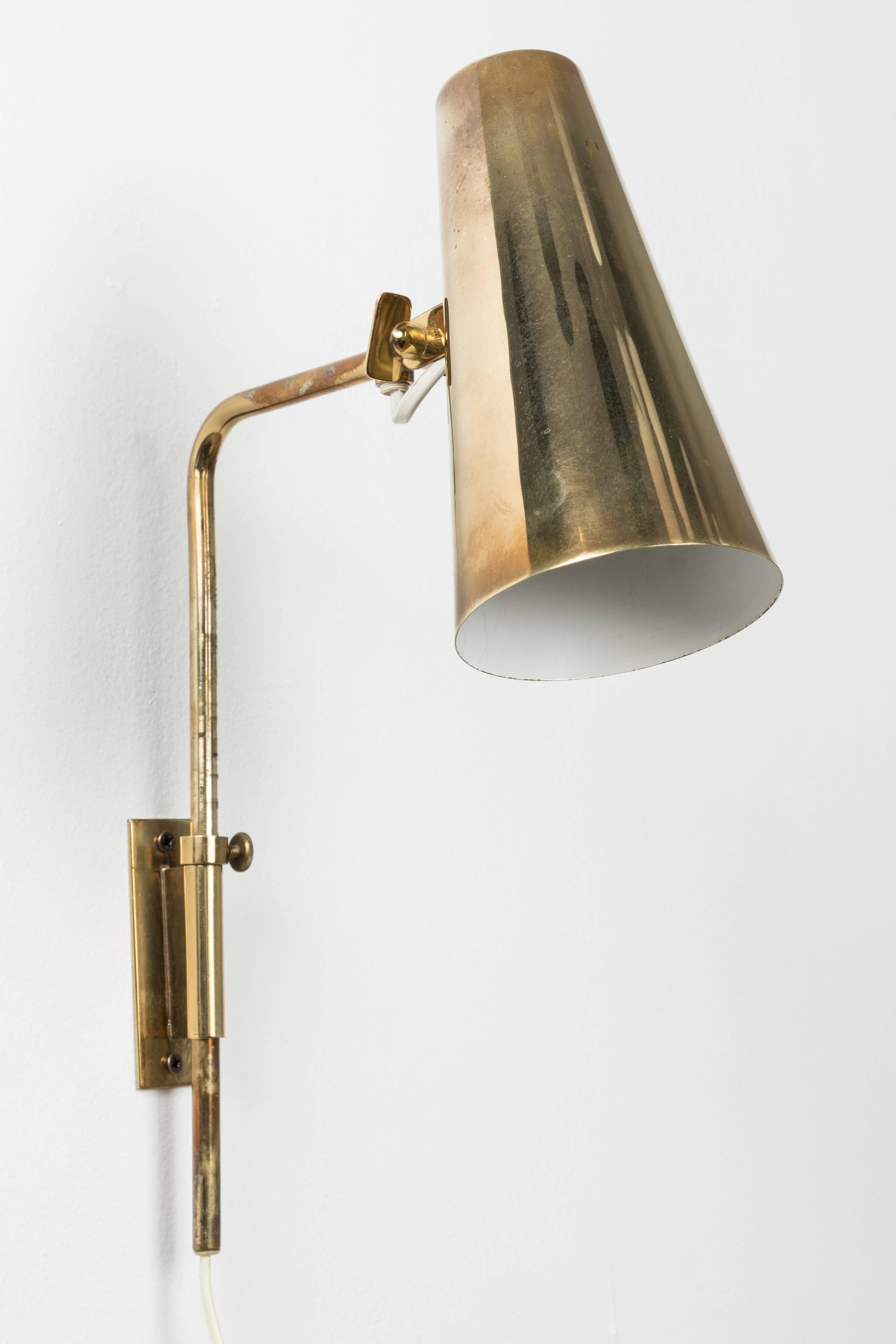1950s Paavo Tynell 9459 wall lights for Taito Oy. These rare and exceptionally refined wall lights are executed in a rich and attractively patinated brass. Signed with impressed manufacturer's mark to shade of each example, circa 1950, Finland.