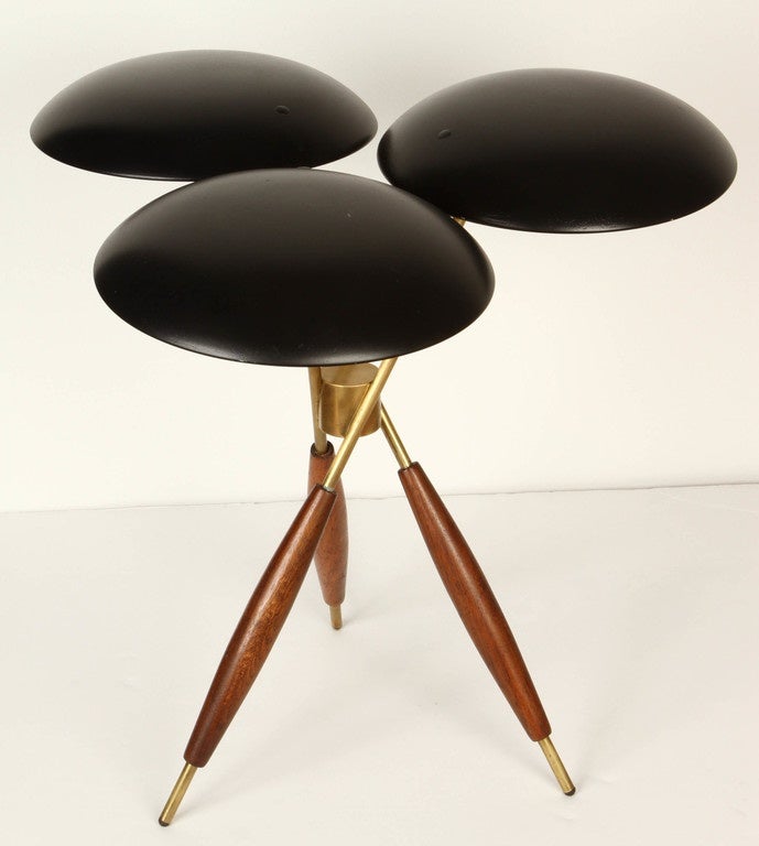 1950s Gerald Thurston tripod table lamp for Lightolier. Executed with black painted metal shades over a tripod base of brass and wood, USA, circa 1950s. Perhaps the rarest, most iconic and heavily sought after of all the legendary Gerald Thurston's