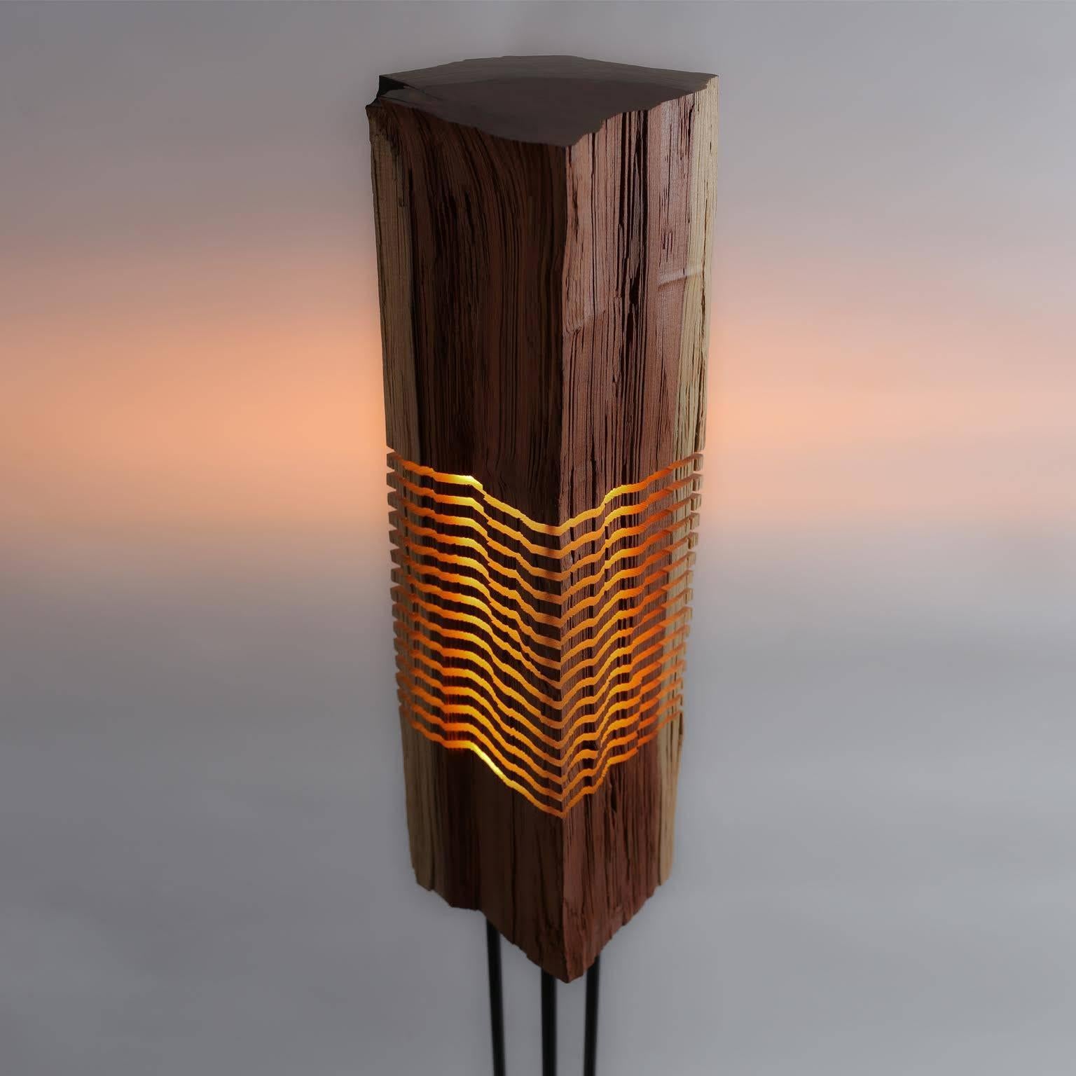 Split grain redwood floor light sculpture. This one of a kind light sculpture is hand made by 20th century artist Paul Foeckler from a reclaimed redwood trunk with a hollowed core that is illuminated with a built-in dimmable LED bulb and mounted on