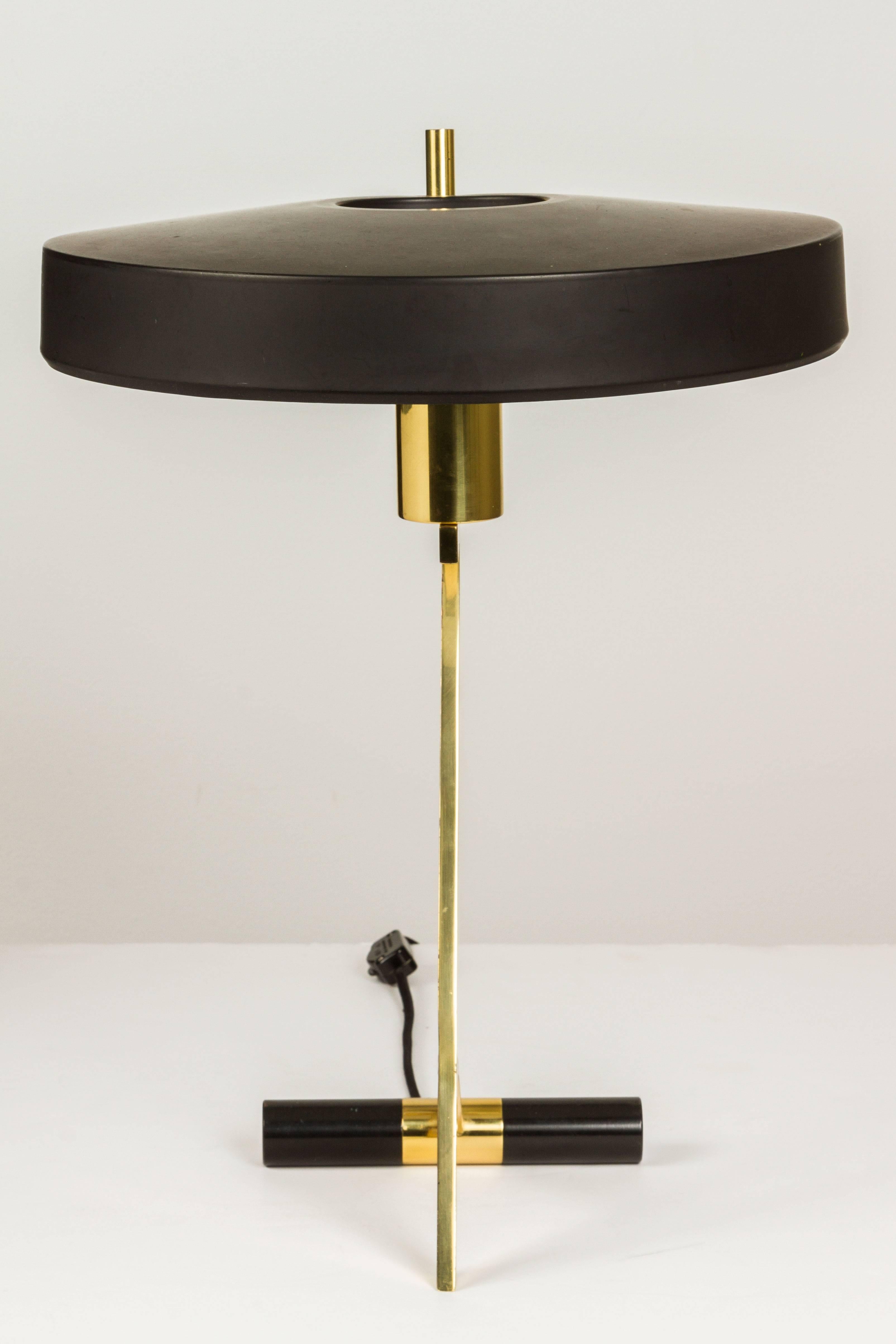 Architectural iconic table lamp executed in black metal and brass by Louis Christiaan Kalff for Philips Eindhoven in 1955.
 