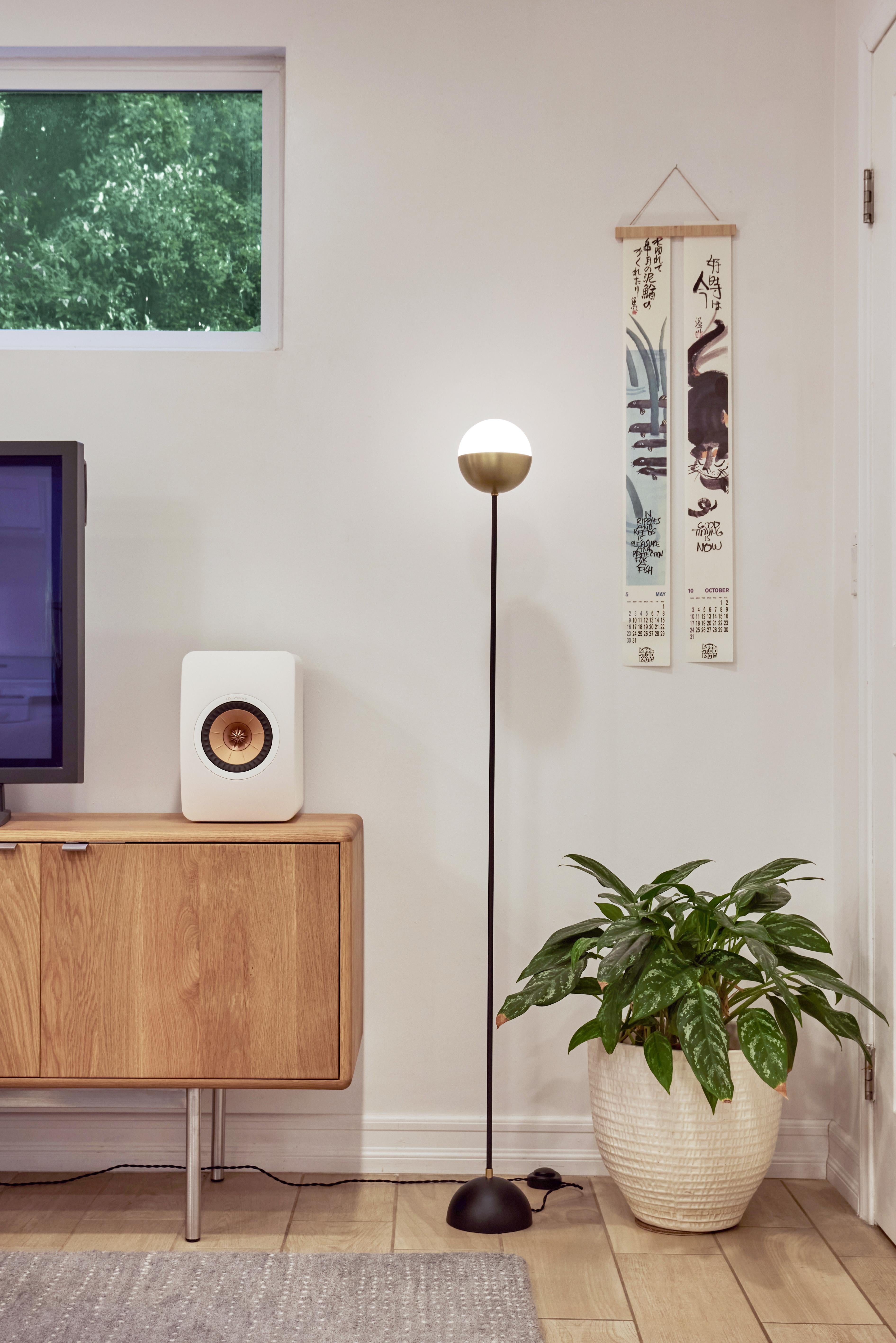 Petite 'KOKO' floor lamp in opaline glass & brass by Alvaro Benitez. 

Hand-fabricated by Los Angeles based designer and lighting professional Alvaro Benitez, this UL listed and highly refined floor lamp is reminiscent of the iconic mid-century