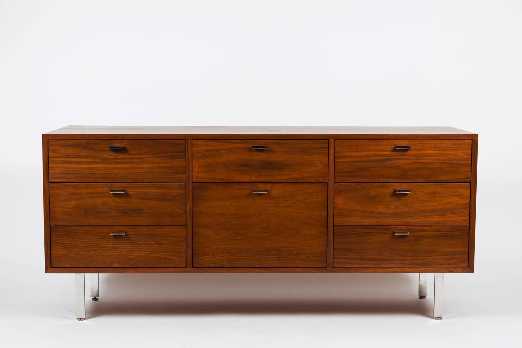 1960s Harvey Probber Walnut Credenza. Retains original manufacturer's label: signed 'Harvey Probber.' Executed in walnut with architectural chromed legs and door pulls. Can be used as a dresser or credenza.