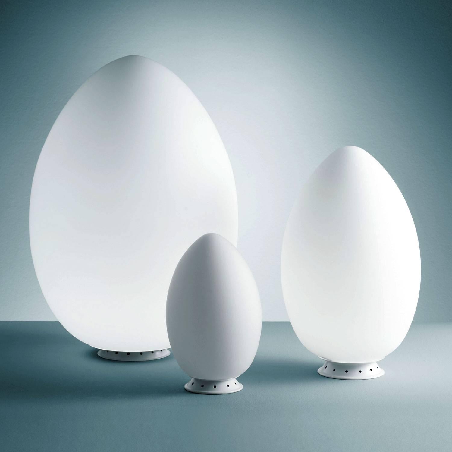 Fontana Arte 'Uovo' table lamp. Executed in satin white blown glass diffusers and painted white metal frames. This listing is for the largest size, an outright sculpture of light that will reign supreme in any room. Also available in small ($480)