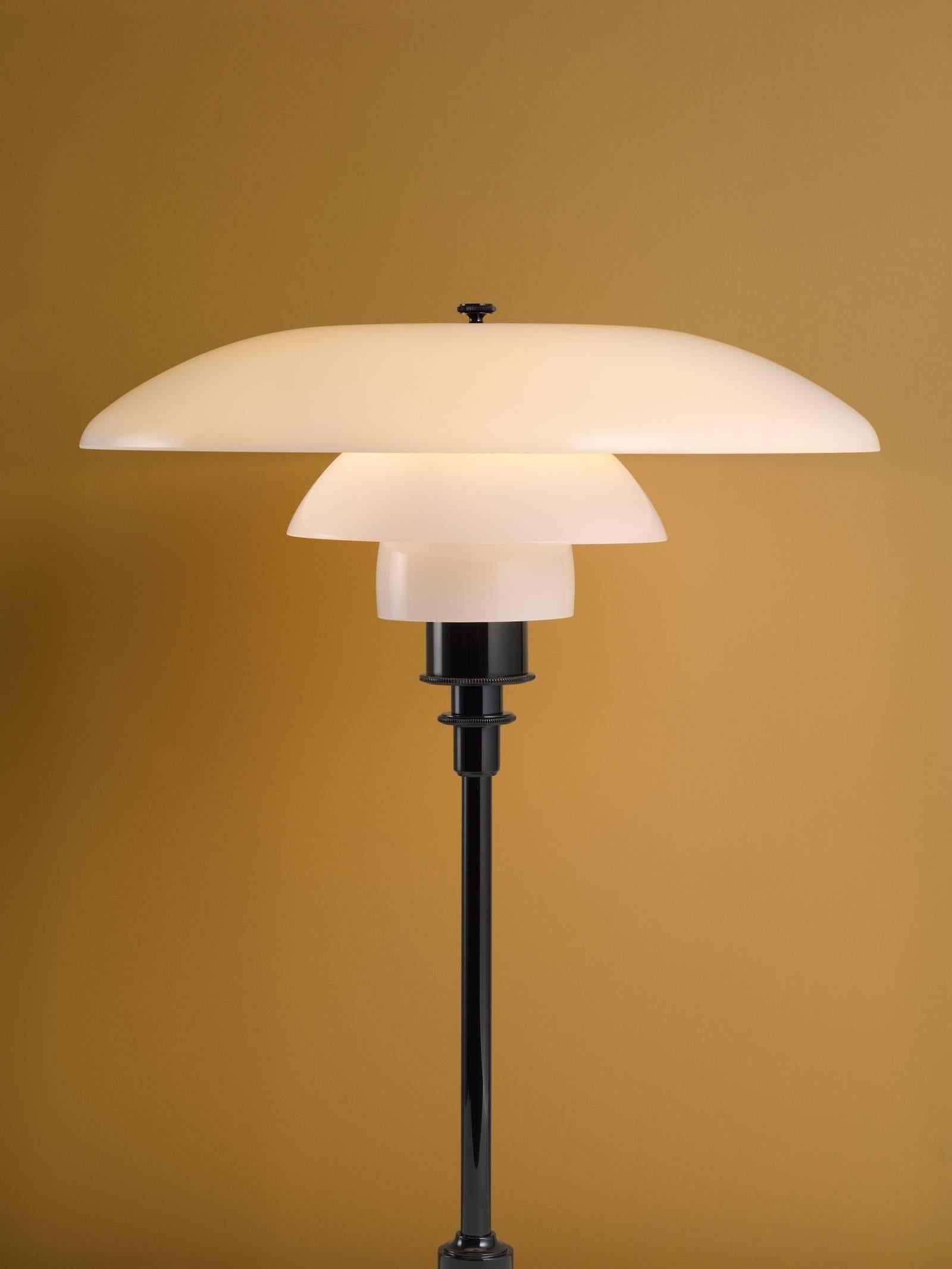 Poul Henningsen opaline glass PH 3½-2½ table lamp for Louis Poulsen. Executed in white opal glass and a chrome or black metallised frame. The Industrial look of the dark metallised surface offers a bold, understated look. The mouth-blown white opal