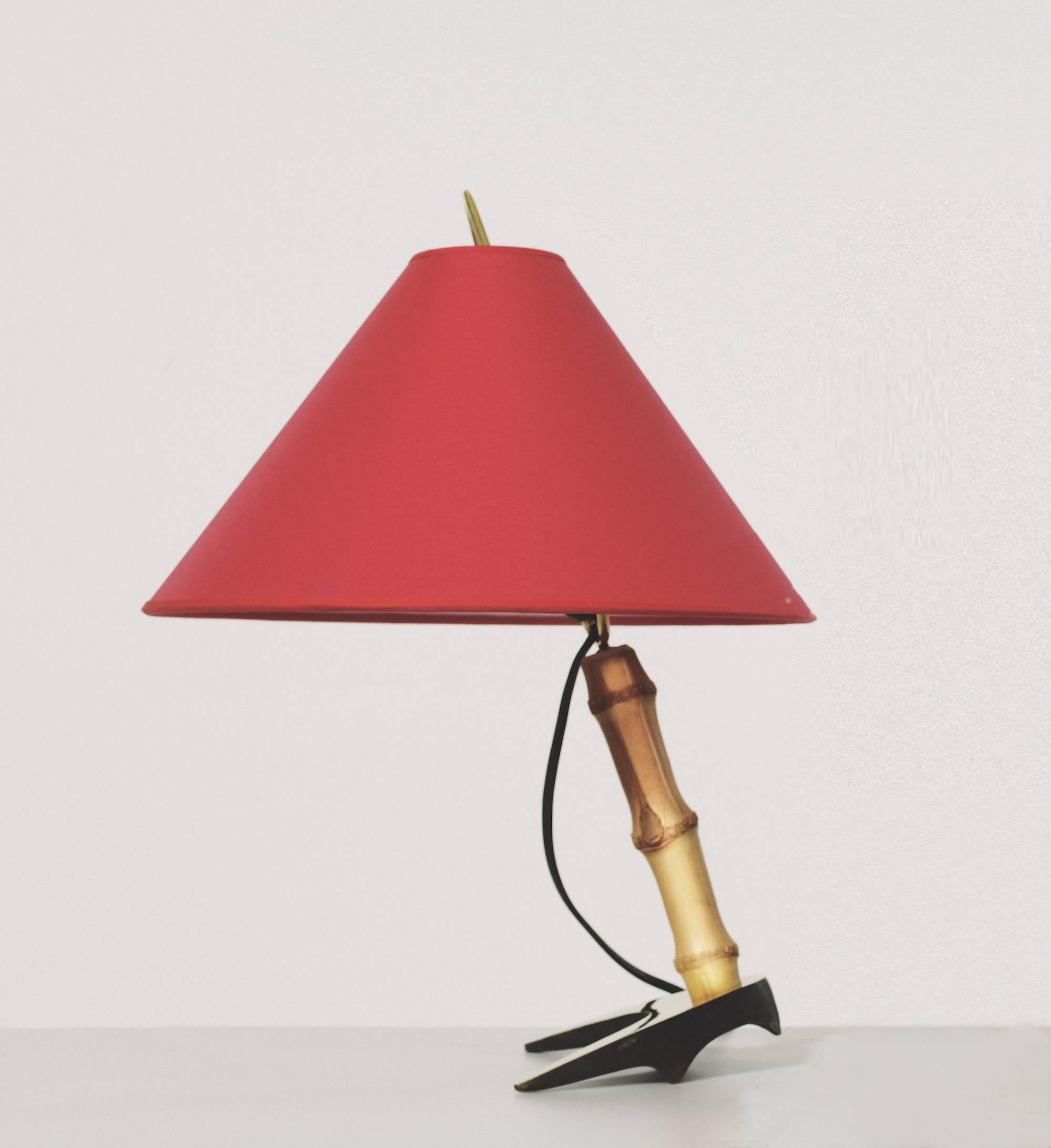 Carl Auböck 'Horseshoe' table lamp. Designed in the 1950s, these versatile and Minimalist Viennese table lamps are executed in bamboo and brass with a heavy horseshoe-shaped solid brass base. Includes sculptural hard paper shade by Werkstätte Carl