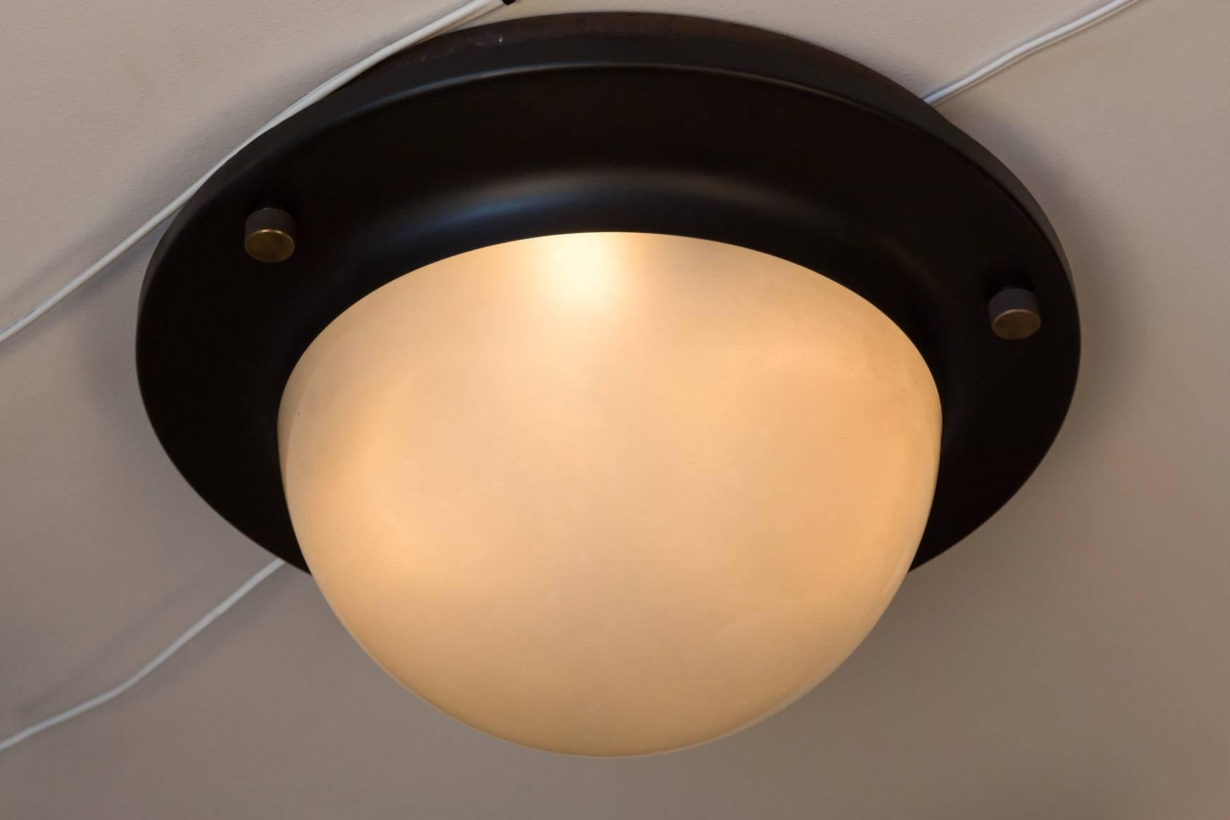 1960s Luigi Caccia Dominioni large 'Tommy' Ceiling Light for Azucena. An large-scale and iconic design executed in black painted metal, brass hardware and opaline glass, Italy, circa 1965.

Azucena was one of the most innovative lighting design