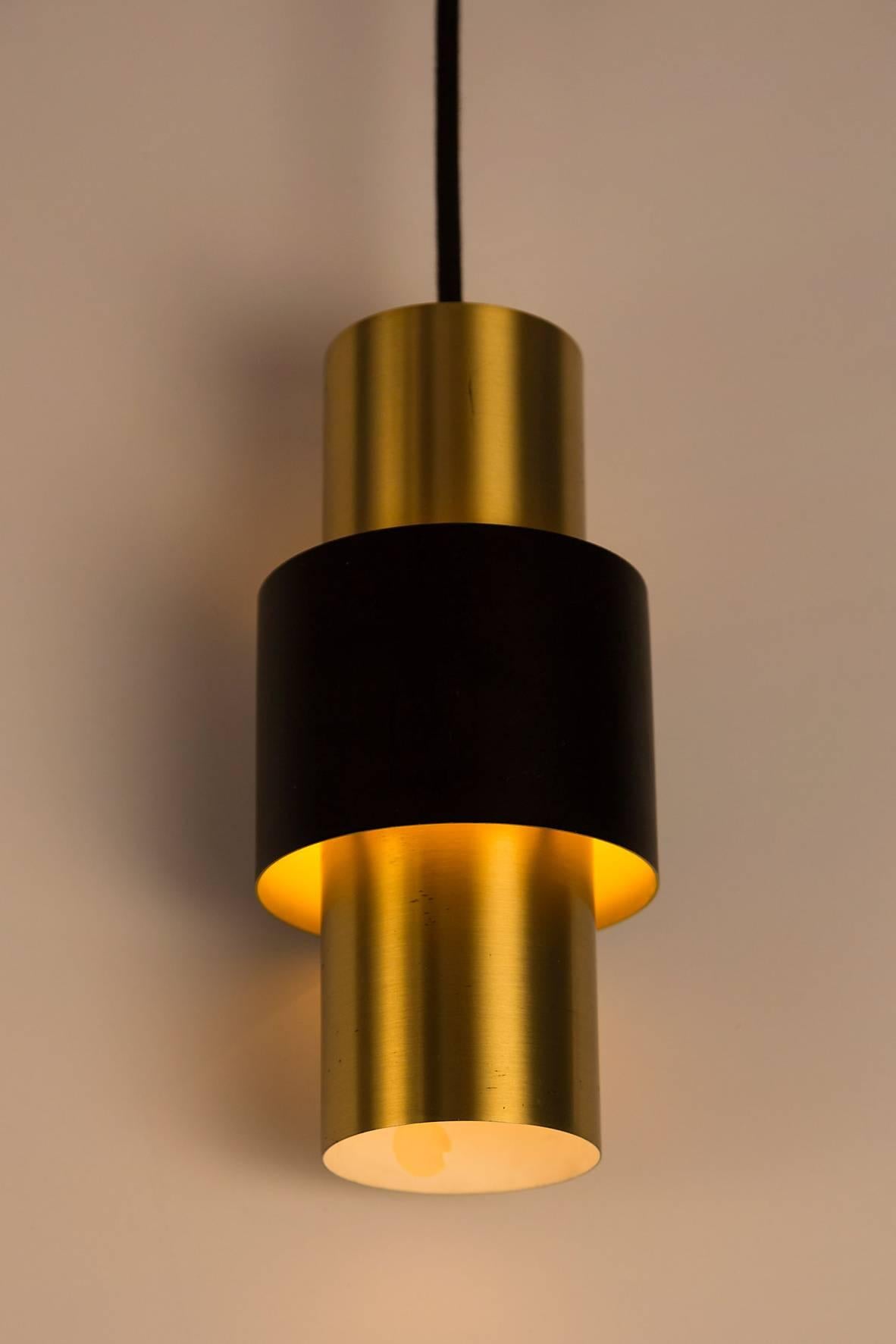 1950s Jo Hammerborg 'Saturn' pendants for Fog and Mørup. A Minimalist Danish modern design Classic executed in brass and black enameled metal.

Price is for the set of three.

Not UL listed, but recommended UL listing possible from authorized