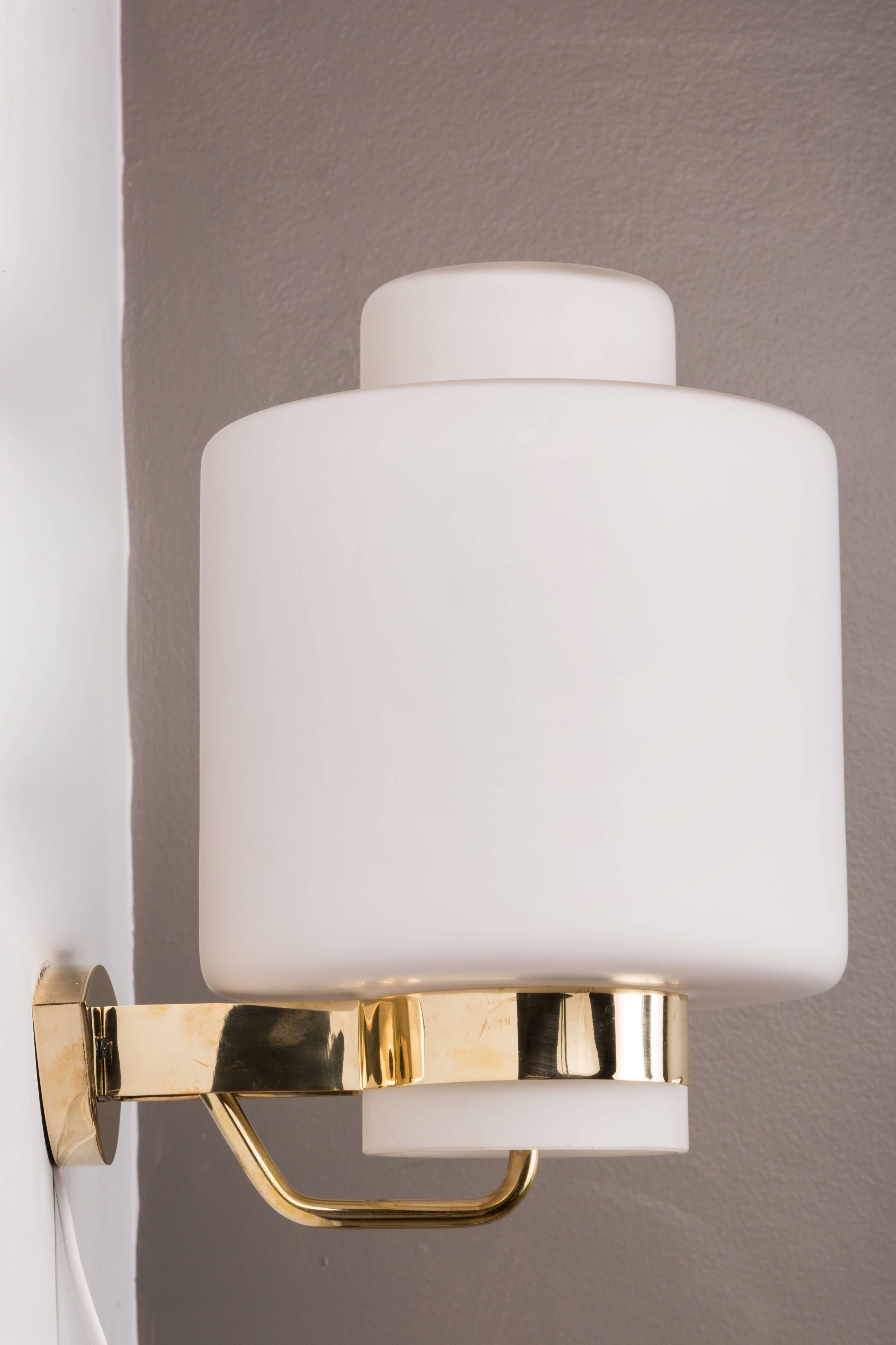 1950s Stilnovo '2120' Brass and Glass Sconces. Executed in brass and thick opaline matte glass. A sculptural and refined design characteristic of 1950s Italian design at its highest level.

Literature: Stilnovo Catalog 1960, p. 46.