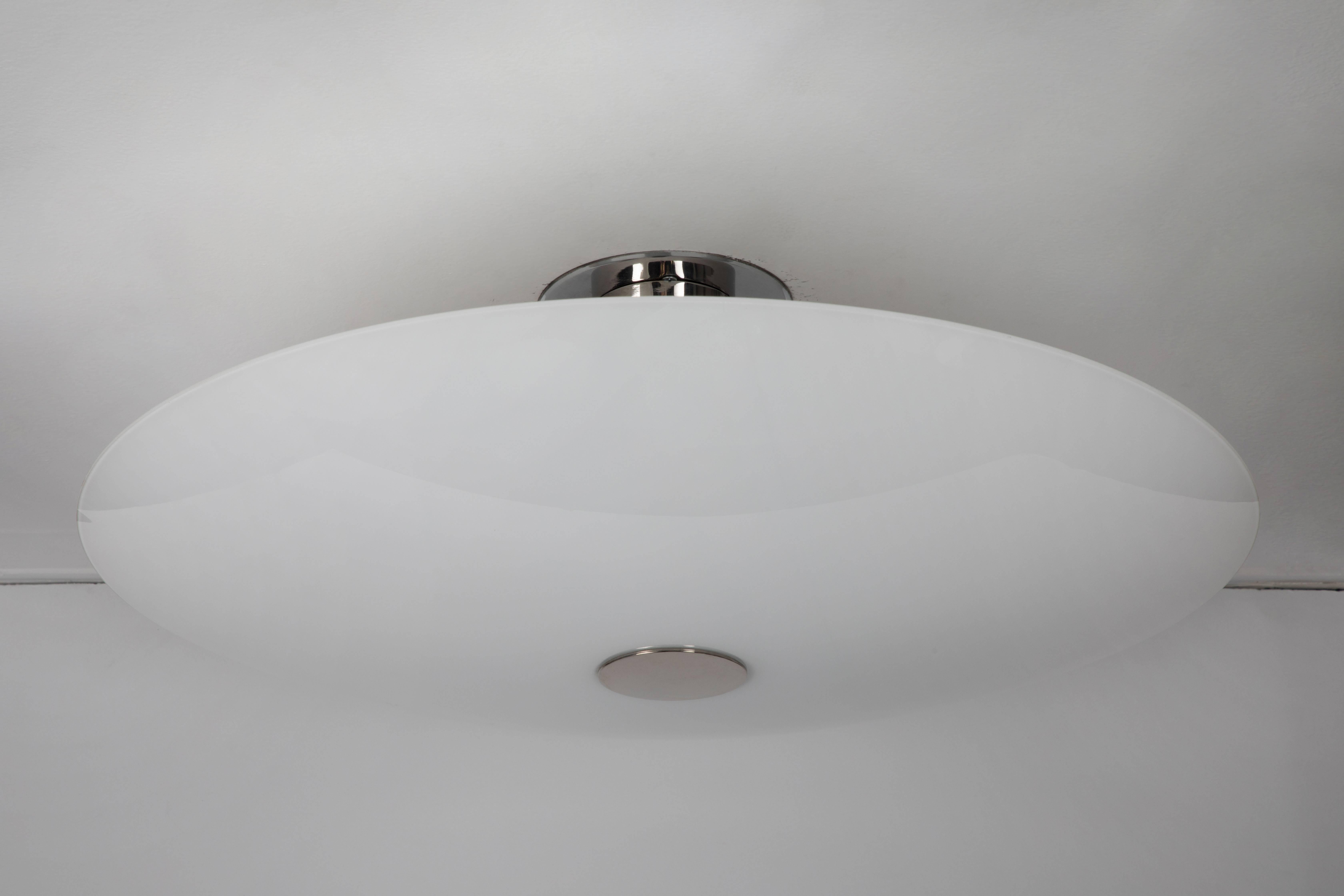 Large, 1960s Florian Schulz 'Gela 55' glass ceiling or wall lamp. Comprised of a single large shield-like dome of opaline glossy glass mounted over a polished steel column that accommodates five medium base standard sockets for ample lighting. A