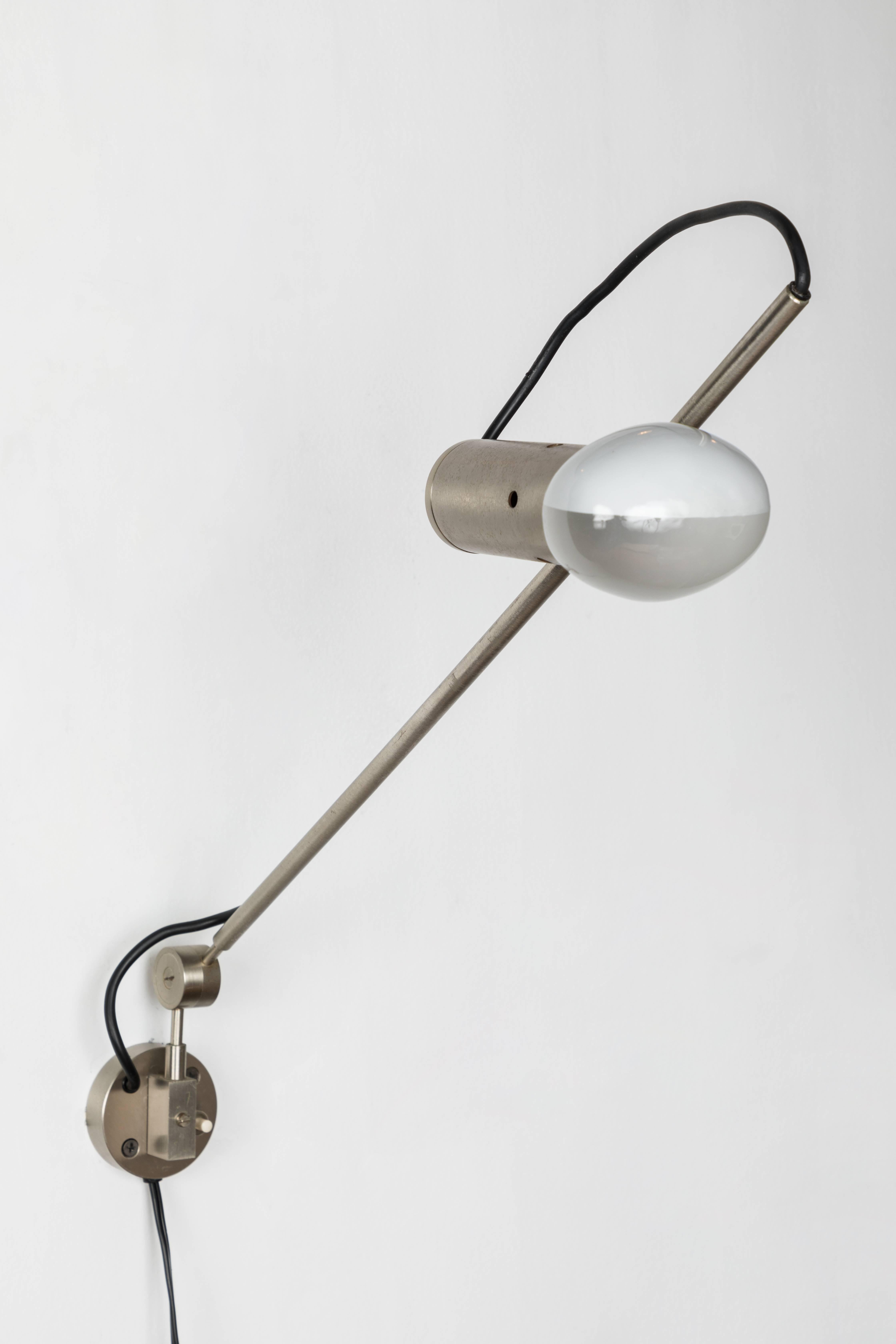 1955 Tito Agnoli model 194 wall light for O-Luce. An extremely rare matched pair executed in nickeled metal. One of the most refined Minimalist Italian designs of the midcentury. A highly adjustable wall light, the arms can be rotated up/down and