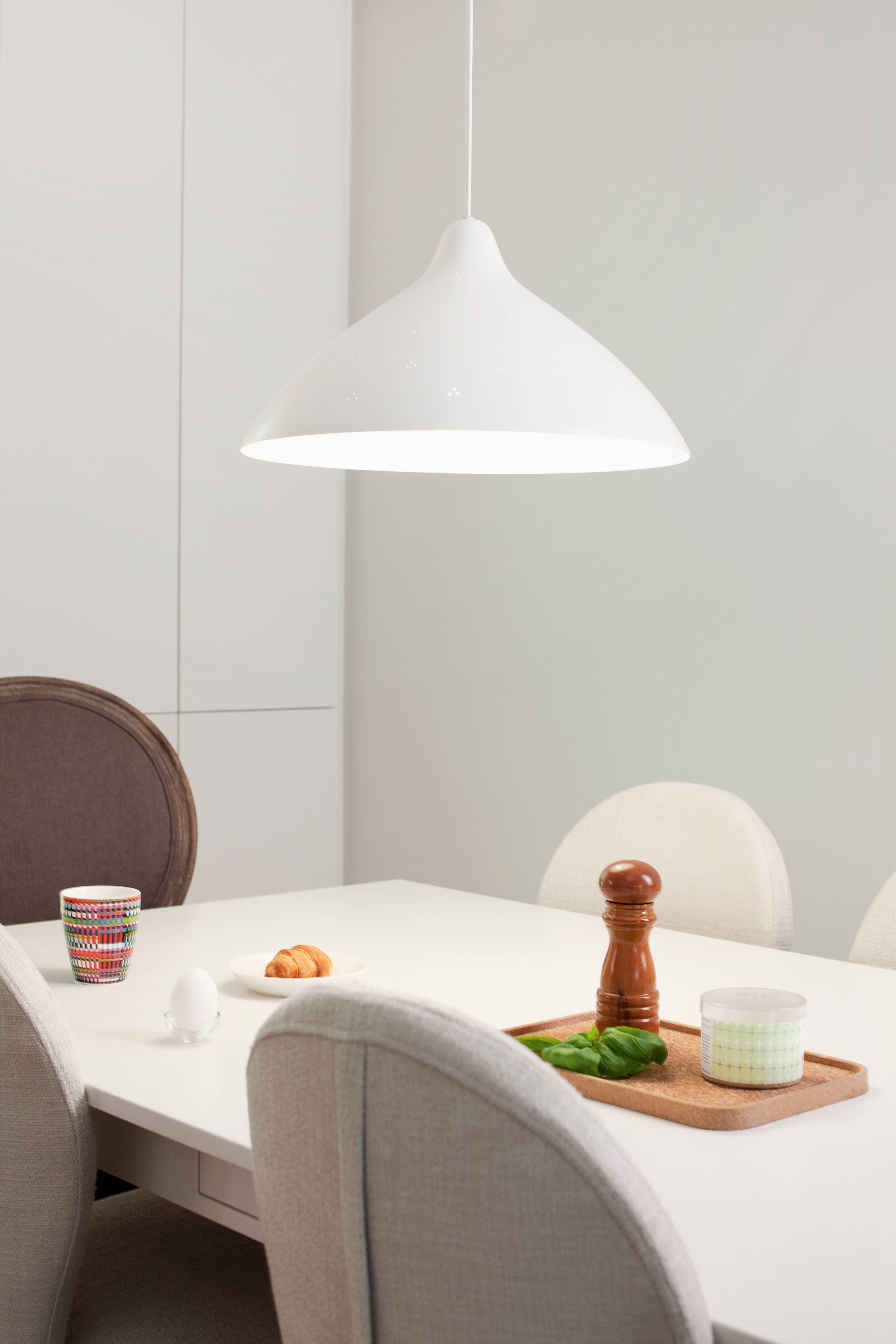 Lisa Johansson-Pape large white perforated metal pendant for Innolux Oy.

Originally designed in 1947, these authorized re-editions are true to the original charming simplicity of Pape's iconic design. The white interior of each metallic shade