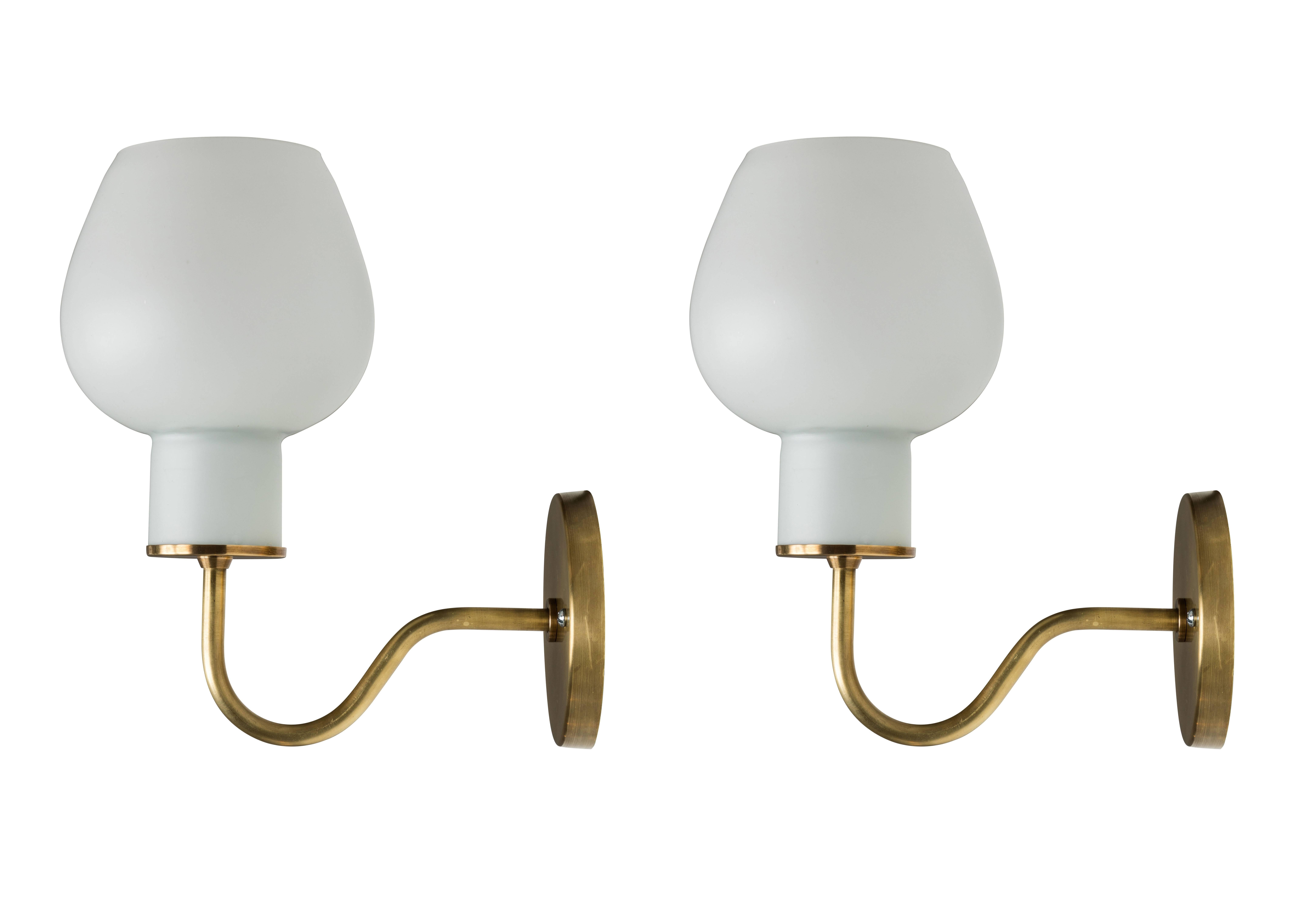 1950s Vilhelm Lauritzen 'Christiansborg' sconces for Louis Poulsen. Executed in opaline matte glass and brass. The Christiansborg offers gentle illumination via the opaline glass, which generate softer tones in the room, and is simply ideal for