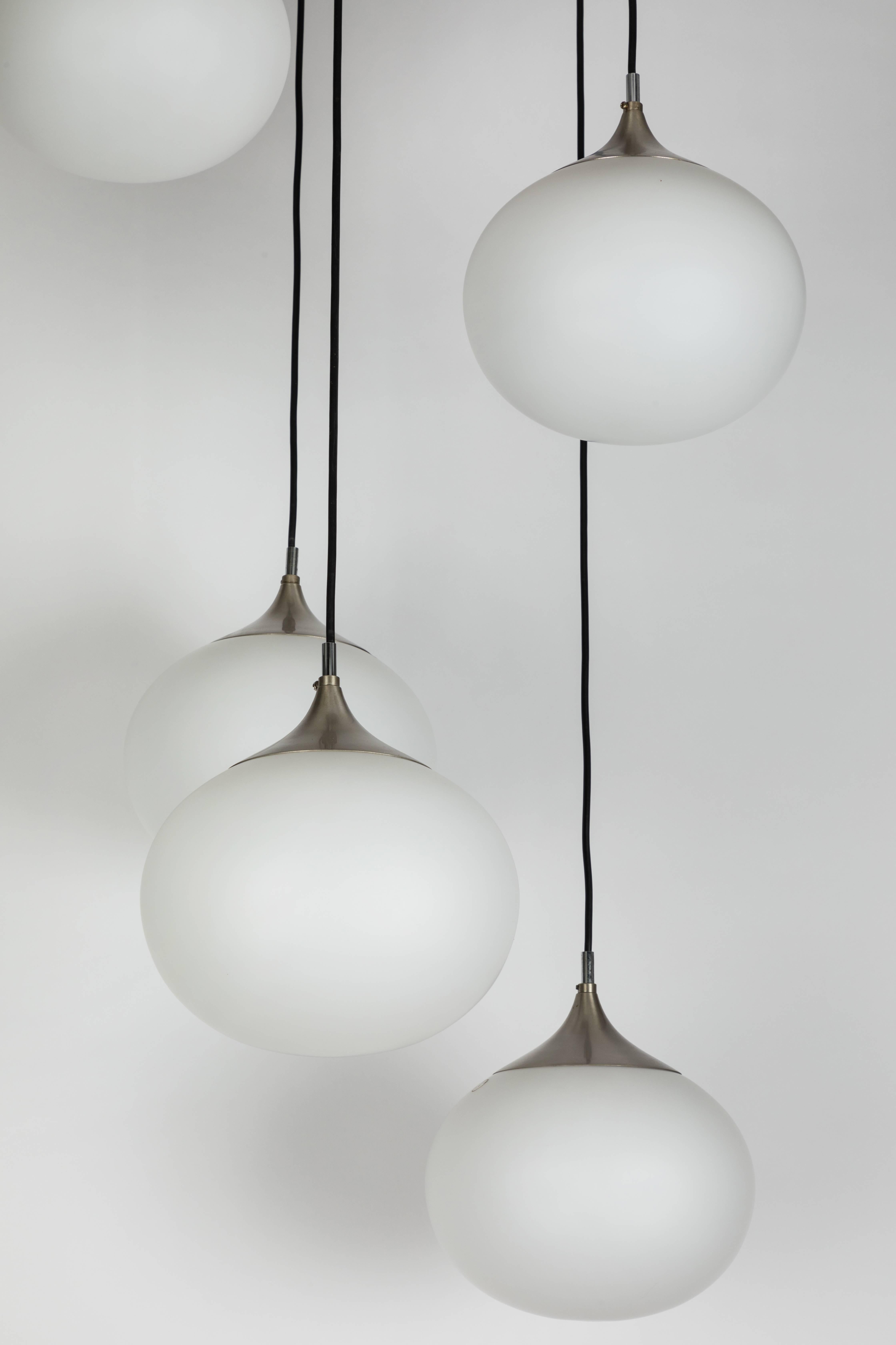 Large 1960s Peill & Putzler five-globe chandelier. A substantial piece in the manner of Stilnovo. Executed in brushed aluminum, chrome and five large opaline glass diffusers. Professionally rewired for us electrical. Retains original manufacturer's