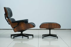 Pair of Vintage Eames 670 Rosewood Lounge Chairs with Ottomans
