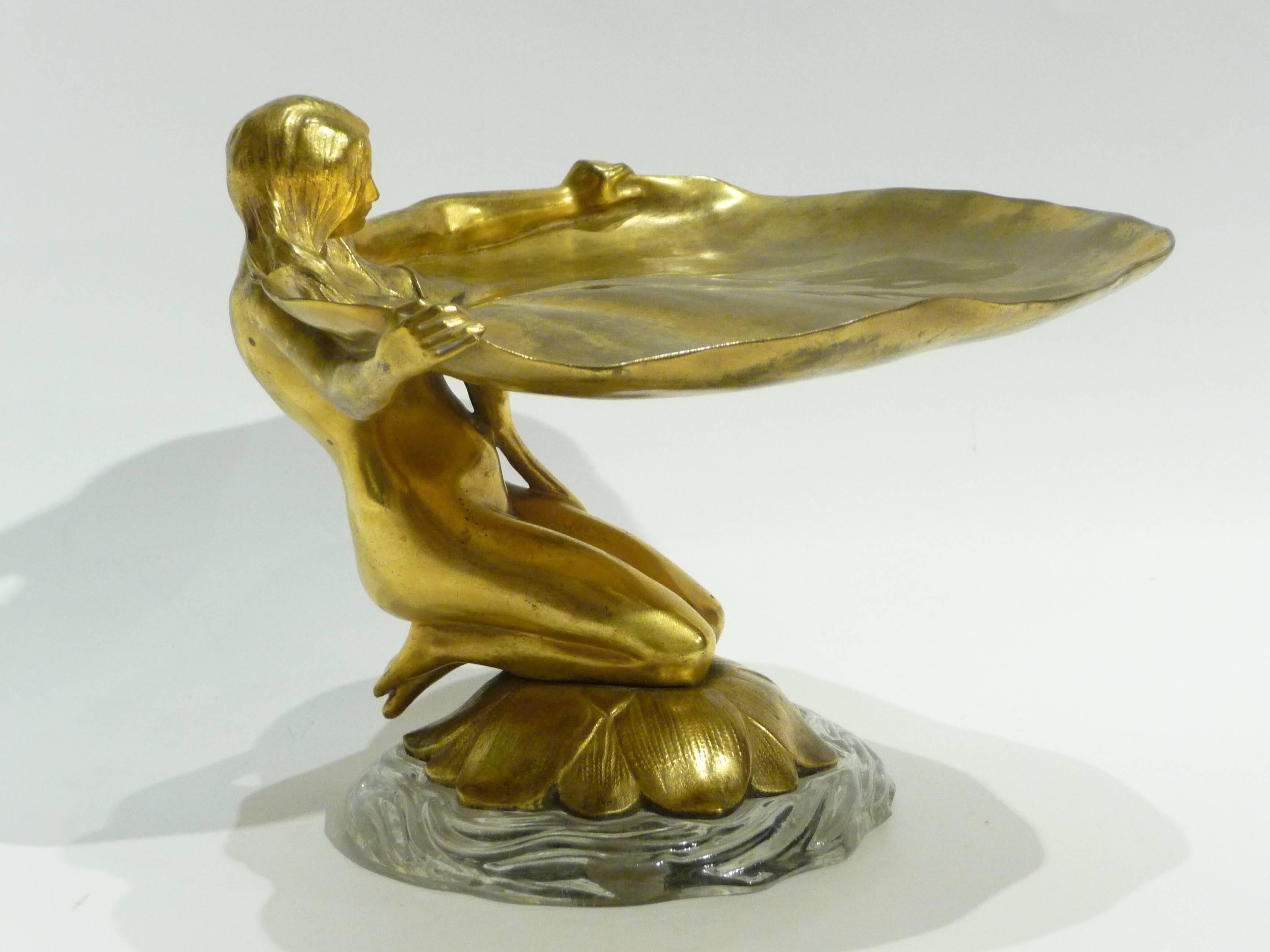 Maurice Bouval
"Femme Nénuphar."
An Art Nouveau gilt bronze pin tray; the base in moulded glass.
Signed.