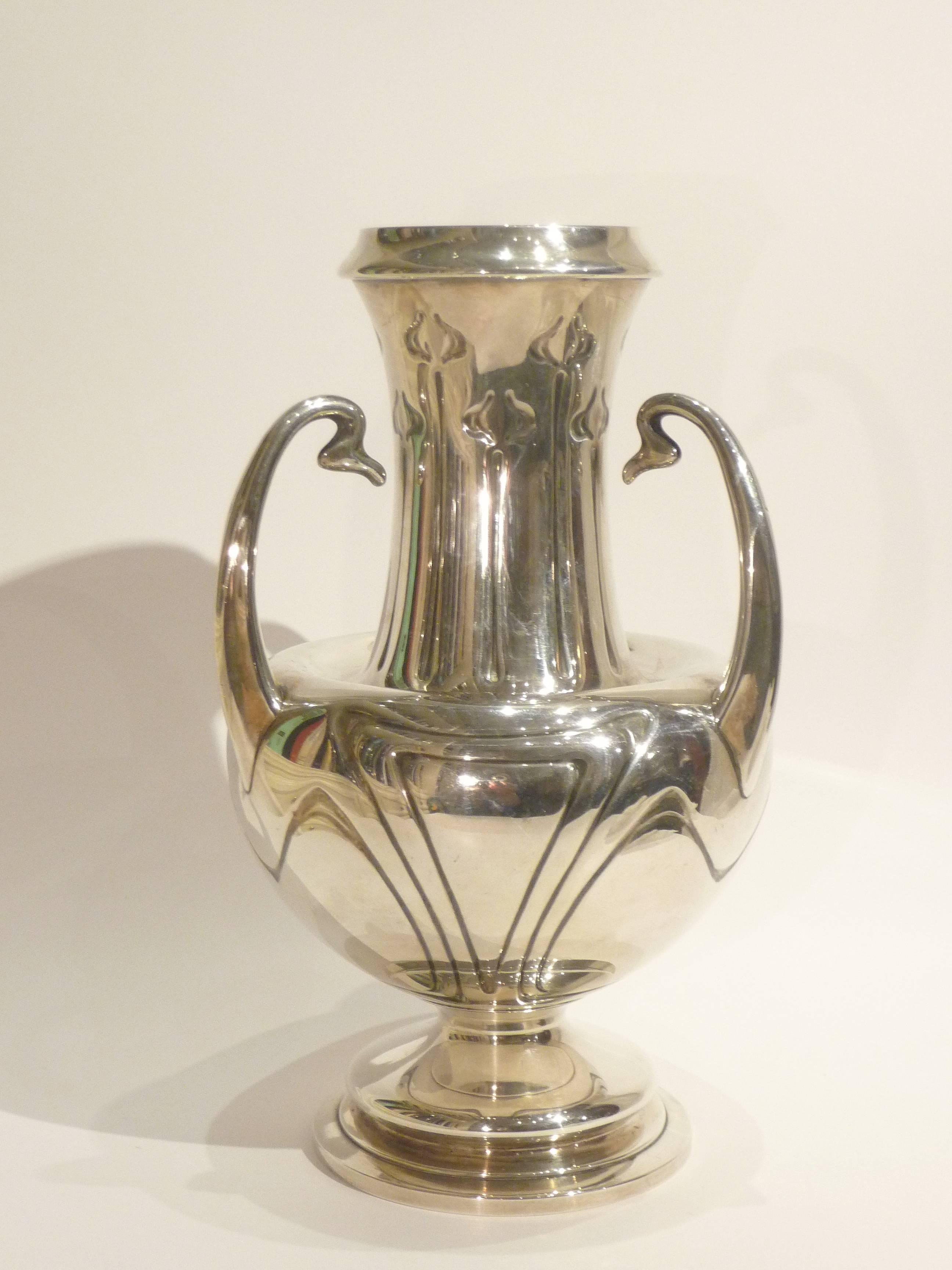 Alphonse Debain.
An Art Nouveau silver vase with a stylized vegetal decor, 
with three handles.
Signed Debain, with maker's mark.
Exhibition: Exposition universelle, Paris, 1900.
 