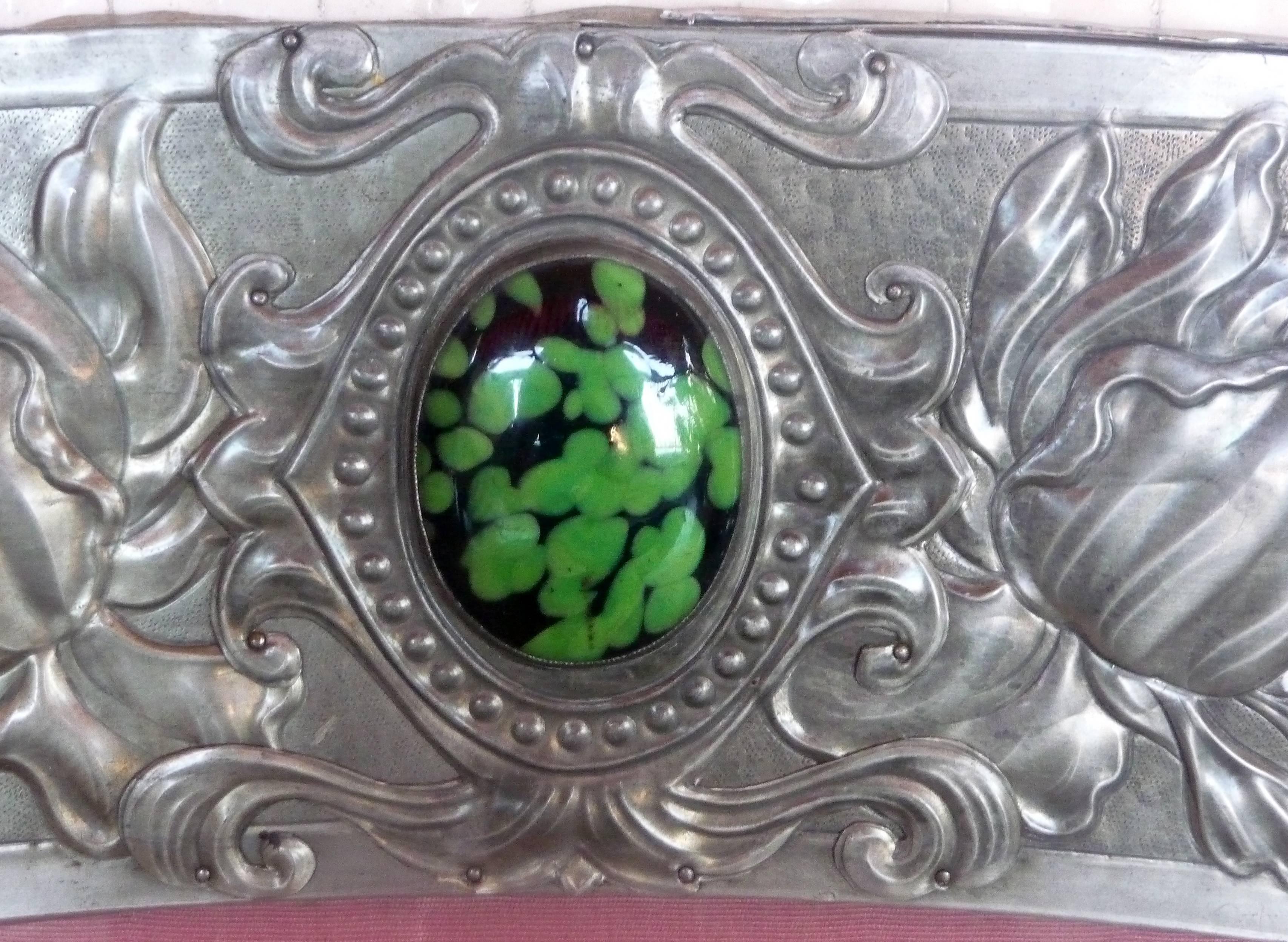 Anonymous
An Art Nouveau silvered pewter frame
Colored cabochons.