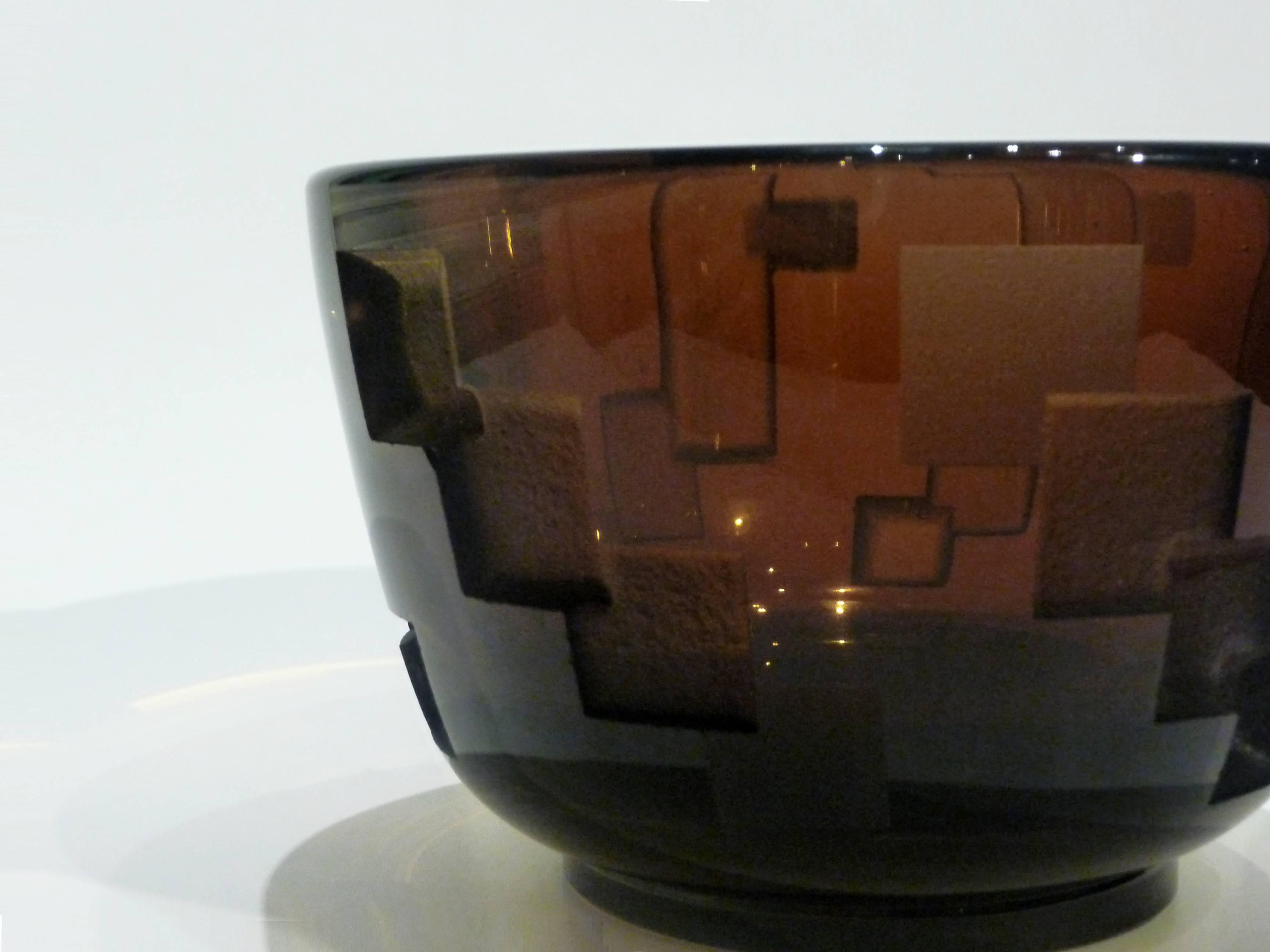 Jean Luce
An Art Deco bowl
Thick amber glass deeply etched with rows of overlapping squares
Signed underneath with the artist’s monogram.