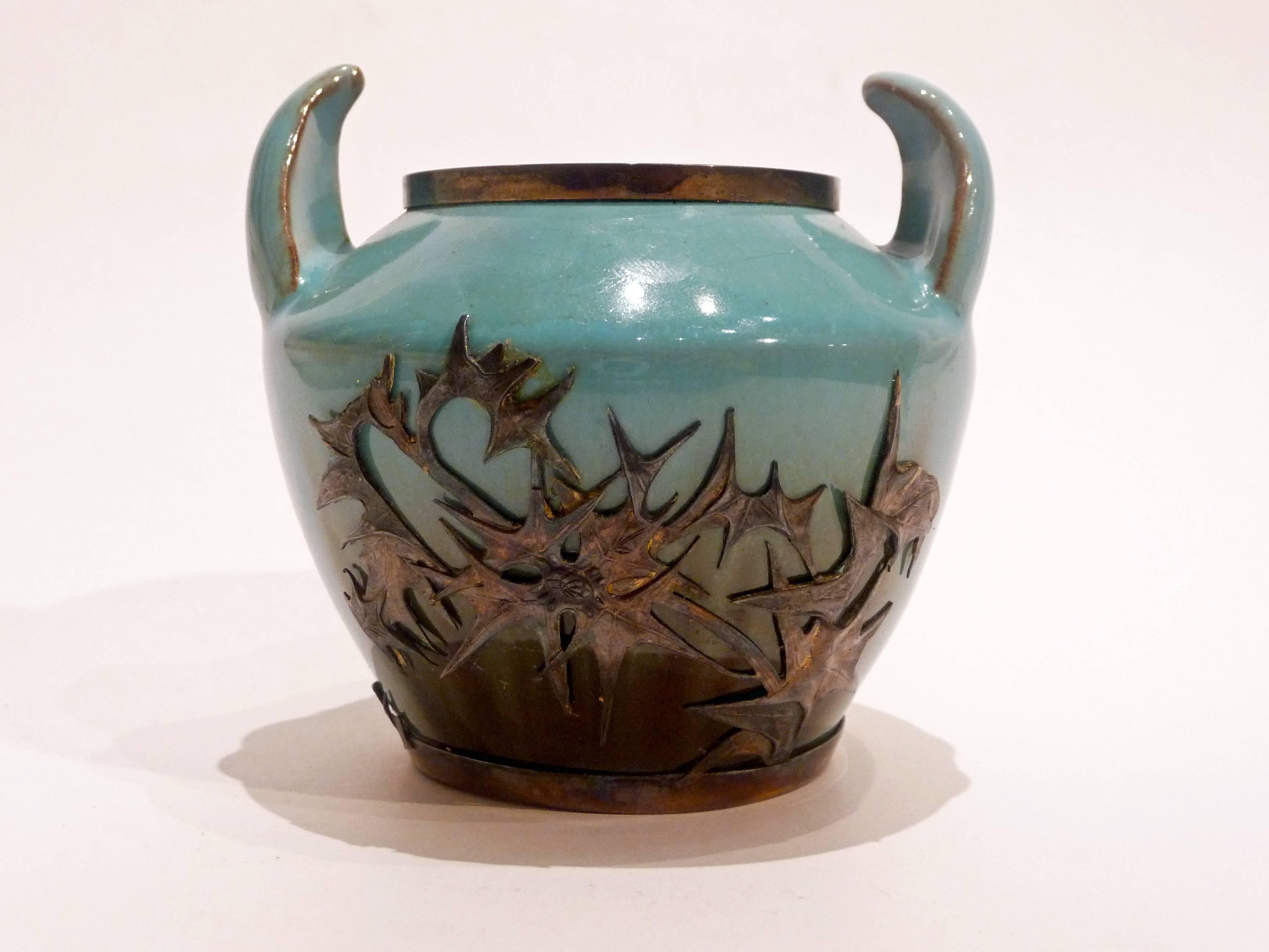 Clément Massier
Lucien Gaillard
An Art Nouveau vase
Turquoise and brown ceramic with two handles in shape of horns imitating Chinese vases
Silver mount decorated with thistles
With silver and maker’s marks
Bibliography: Victor Arwas 