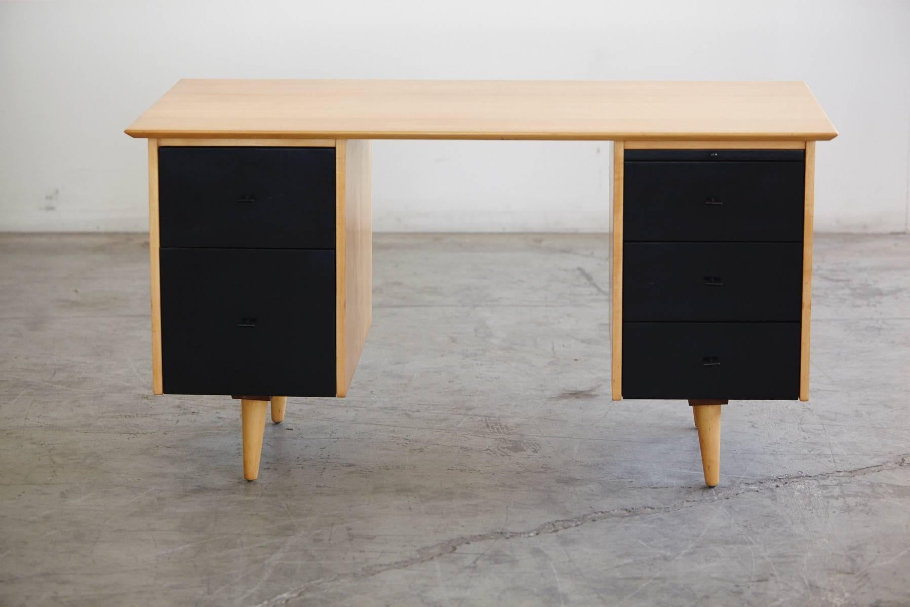 Very stylish solid maple desk with double sided pedestals and 5 solid maple drawers (2 + 3 + 1 tray) in a satin black paint finish . The desk was designed by Paul McCobb for Planner Group and manufactured by Winchendon Furniture Company in the 1950s.