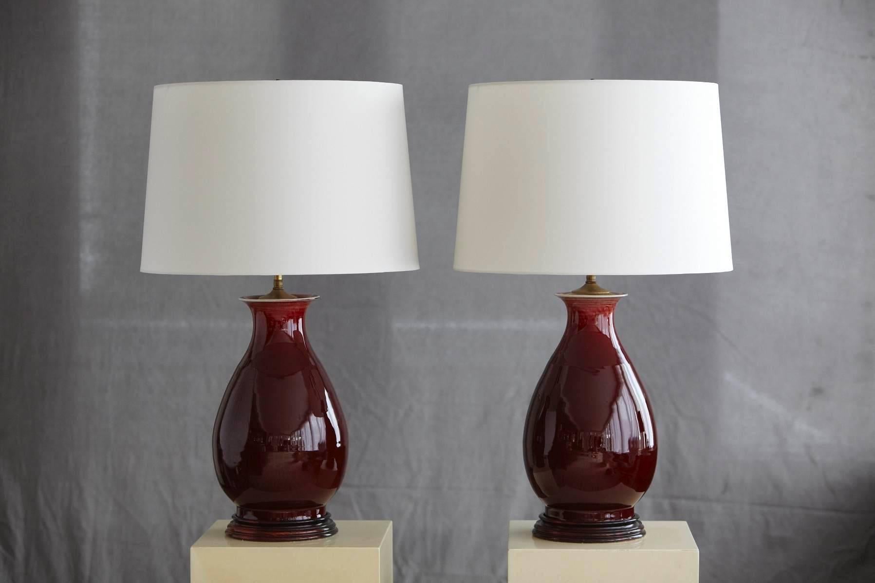 Beautiful pair of deep red glazed Italian ceramic table lamps with new ivory colored shades in excellent condition. The shade height is adjustable.
Dimensions: Base diameter 9