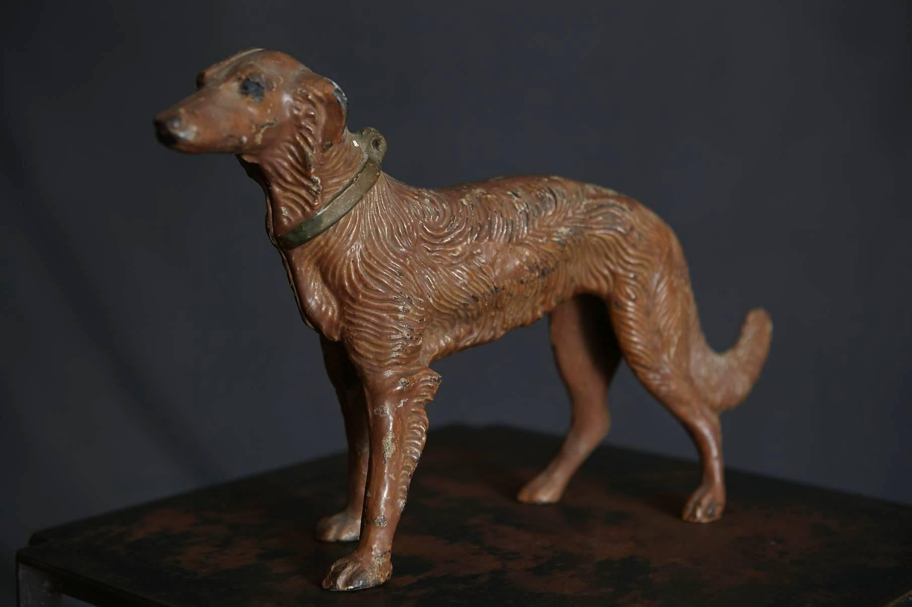 Beautiful Art Nouveau detailed cast iron, cold painted doorstop or object depicting a hunting dog. The dog has a great patina with some little paint loss which gives it a certain charm.