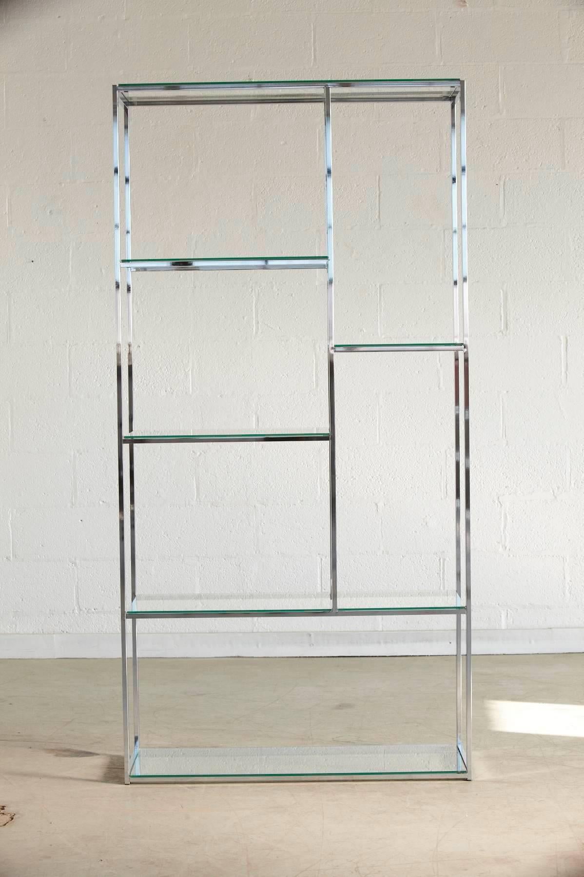 Polished chrome frame with seven glass shelves in a cubistic appearance in the style of Milo Baughman.