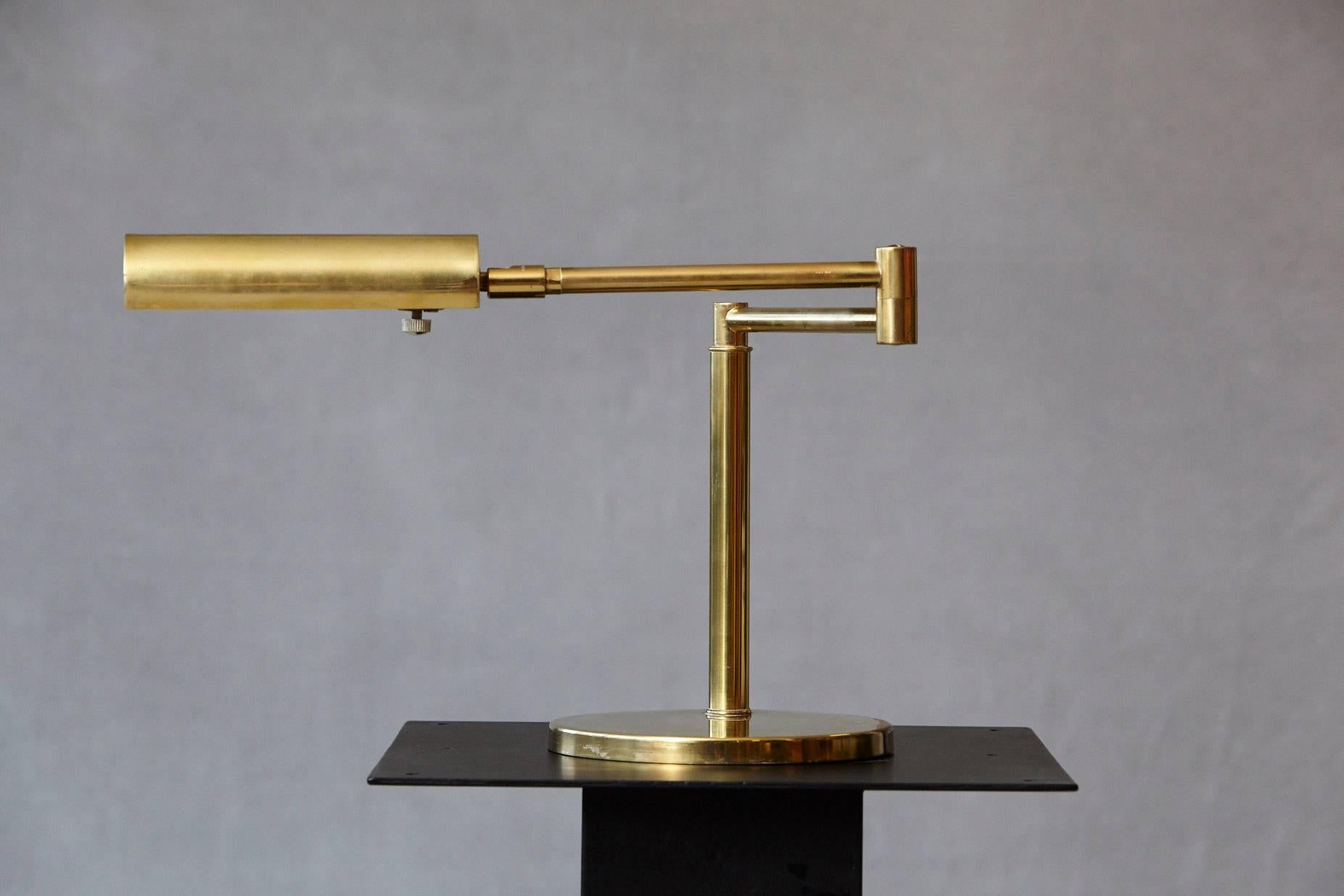 Brass swing arm table lamp by Koch & Lowy with adjustable shade and dimmable switch, marked Koch & Lowy on arm.
The arm is fully extended 27 in long.
Some minor scratches to brass base otherwise great patina.
