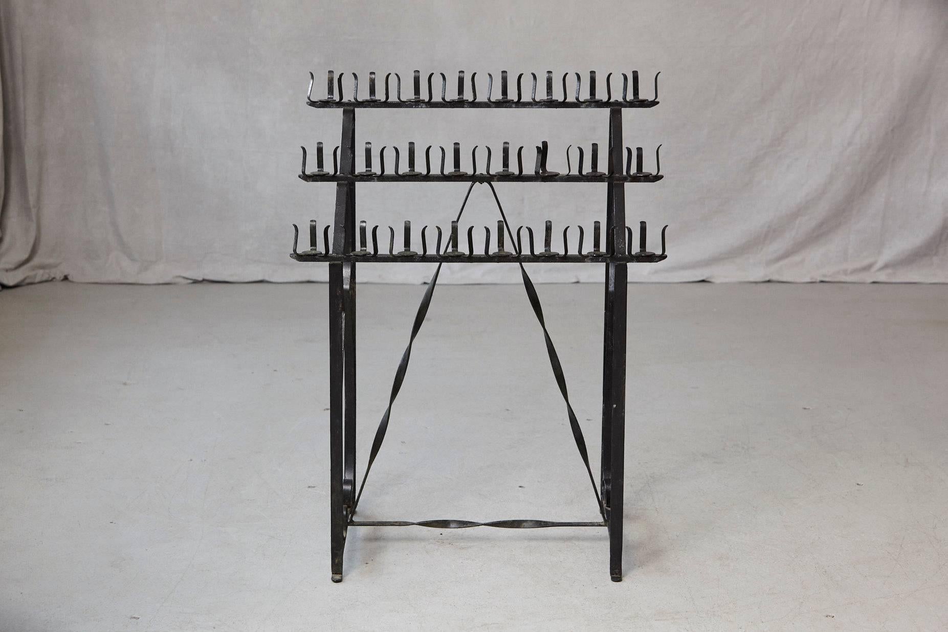Black wrought iron votive candle stand for 24 candles. 
Very decorative for the garden, makes amazing light or to lit a candle for a lot of sins!
Some light rust at the bottom of the stand, please refer to the photos.